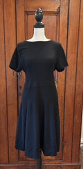 Shop pre-loved dresses. This Eva Mendes black short sleeve fit and flare knee length dress is cute and like new. Size Large. Free shipping within the US.
