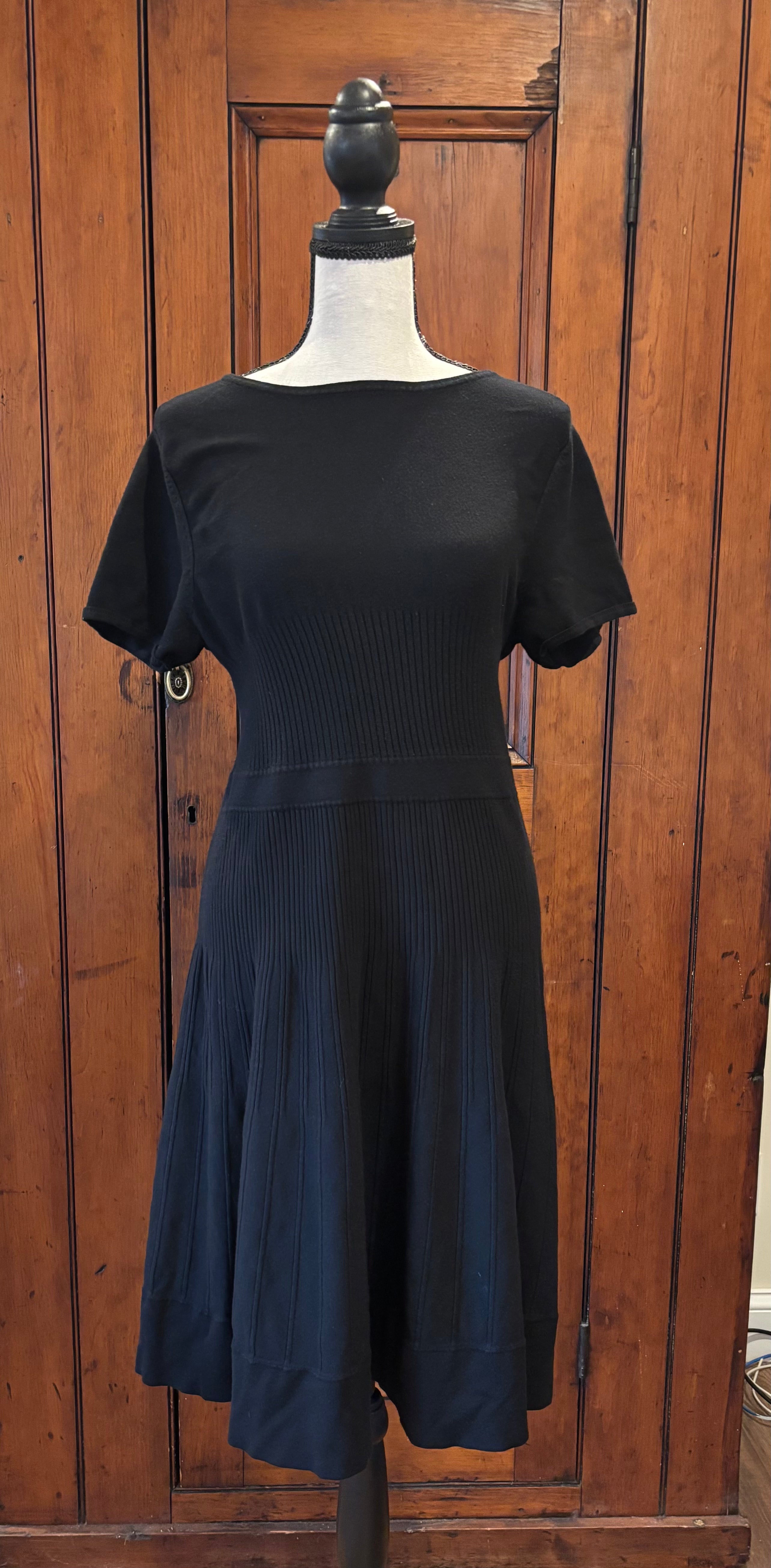 Shop pre-loved dresses. This Eva Mendes black short sleeve fit and flare knee length dress is cute and like new. Size Large. Free shipping within the US.