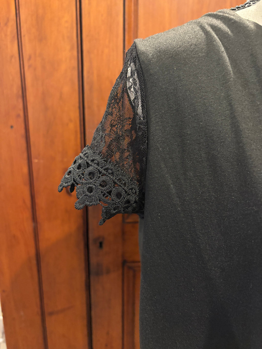 Black V-neck scalloped hem mini dress detail close up beautifully detailed sleeves scalloped edge Sassy and Chic