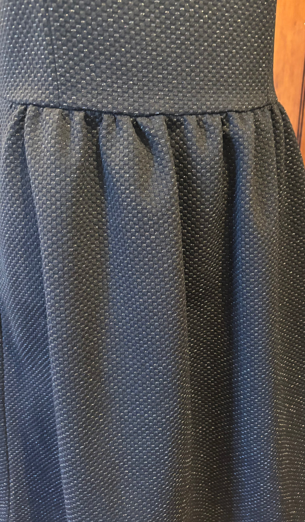 HD in Paris black sleeveless dress detail close up subtle sparkle elegant pleats defined waist Sassy and Chic