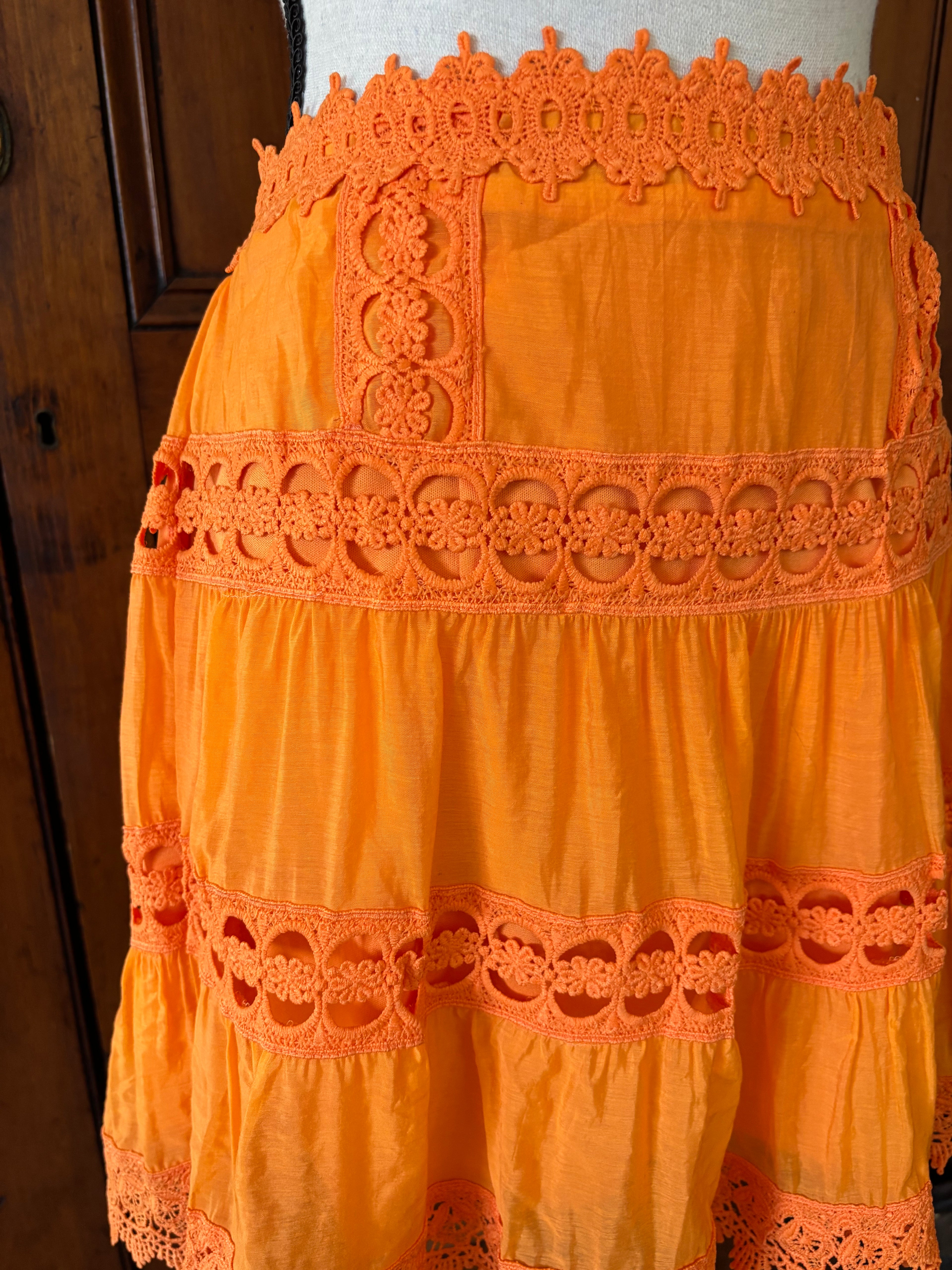 Etiquette  crochet trim mini skirt detail close up crochet trim vibrant orange hue Sassy and Chic