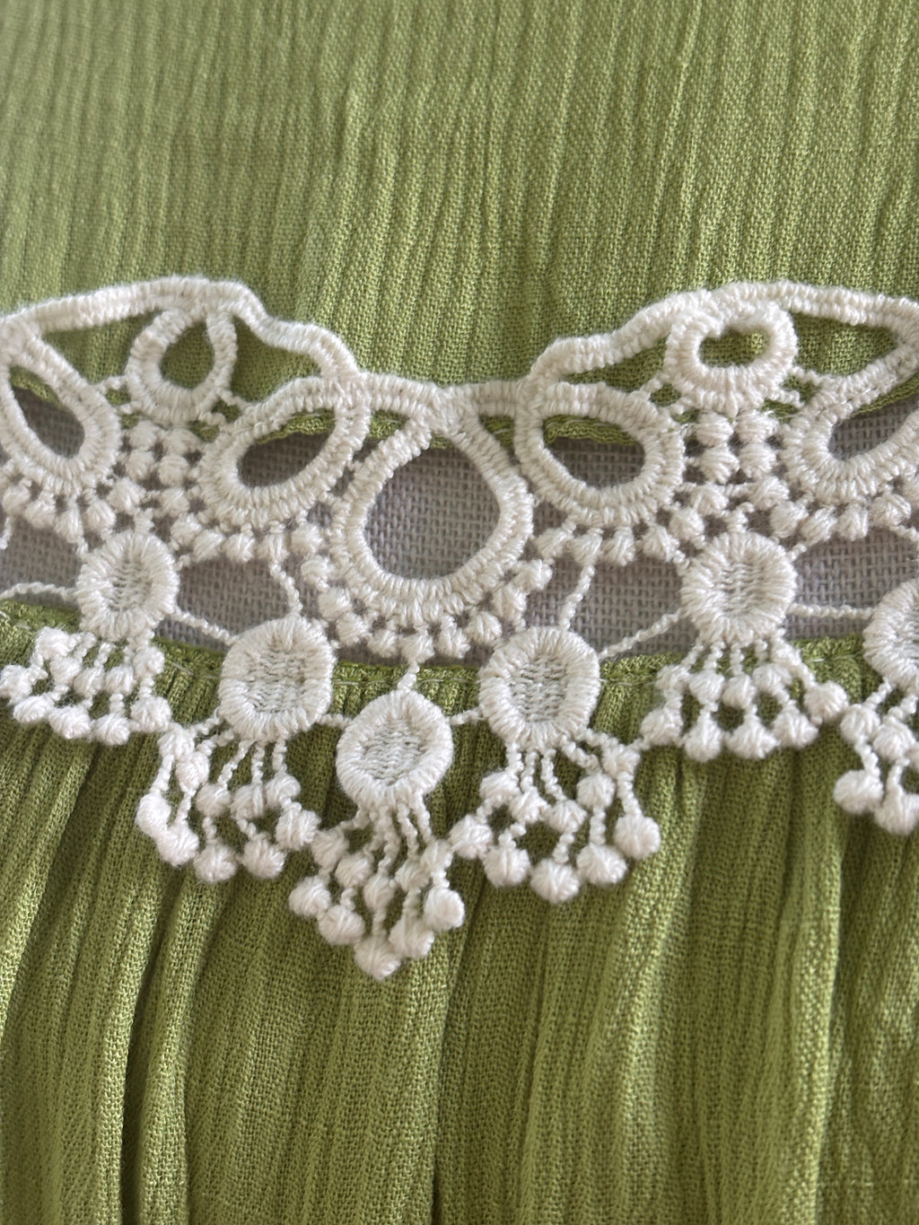 Close-up of white crochet lace medallion detail with dangling bead trim on Hayden LA dress