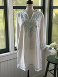 Les Canebiers white embroidered tunic dress on mannequin, split V-neckline with sky blue scrolling medallion embroidery at chest