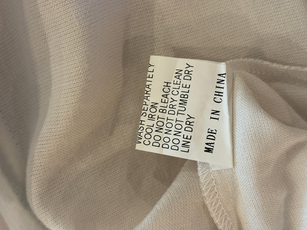 Care label for Les Canebiers white tunic dress — wash separately, line dry