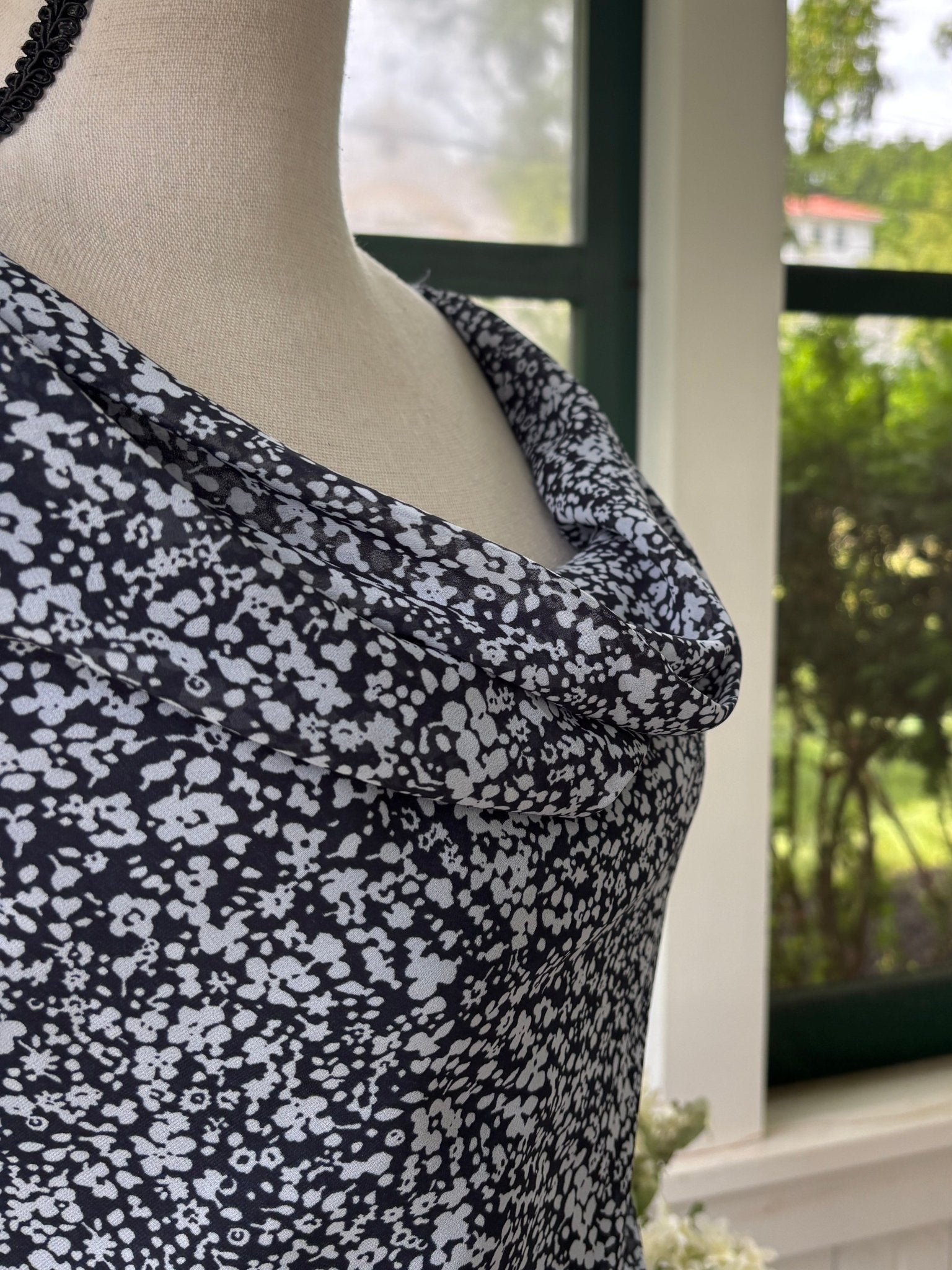 Side view of cowl neck and shoulder strap detail on A&F navy floral dress