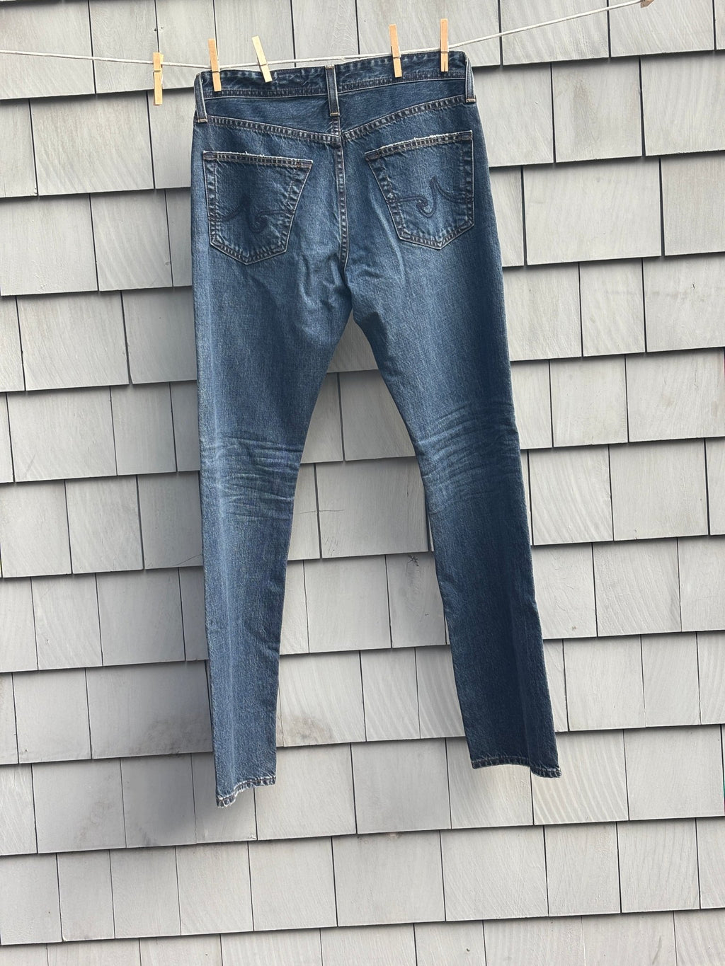 AG Adriano Goldschmied straight leg jeans, back view on clothesline