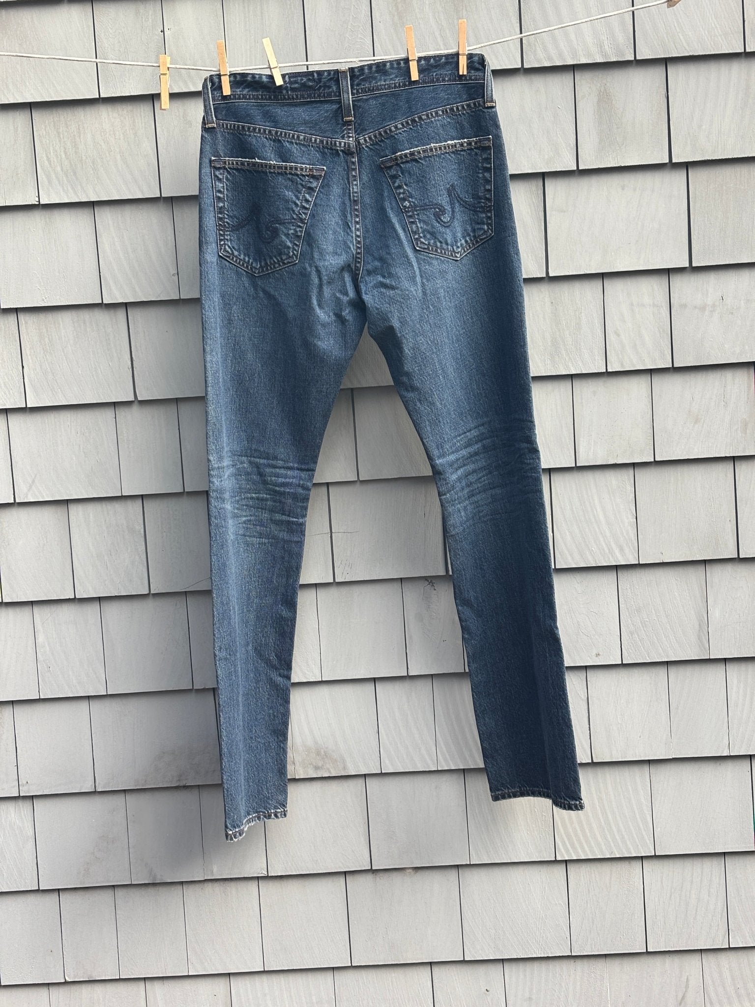 AG Adriano Goldschmied straight leg jeans, back view on clothesline