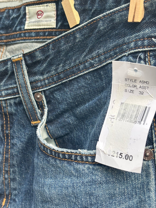 Close-up of AG label and front pocket on distressed straight leg jeans, with $215 price tag