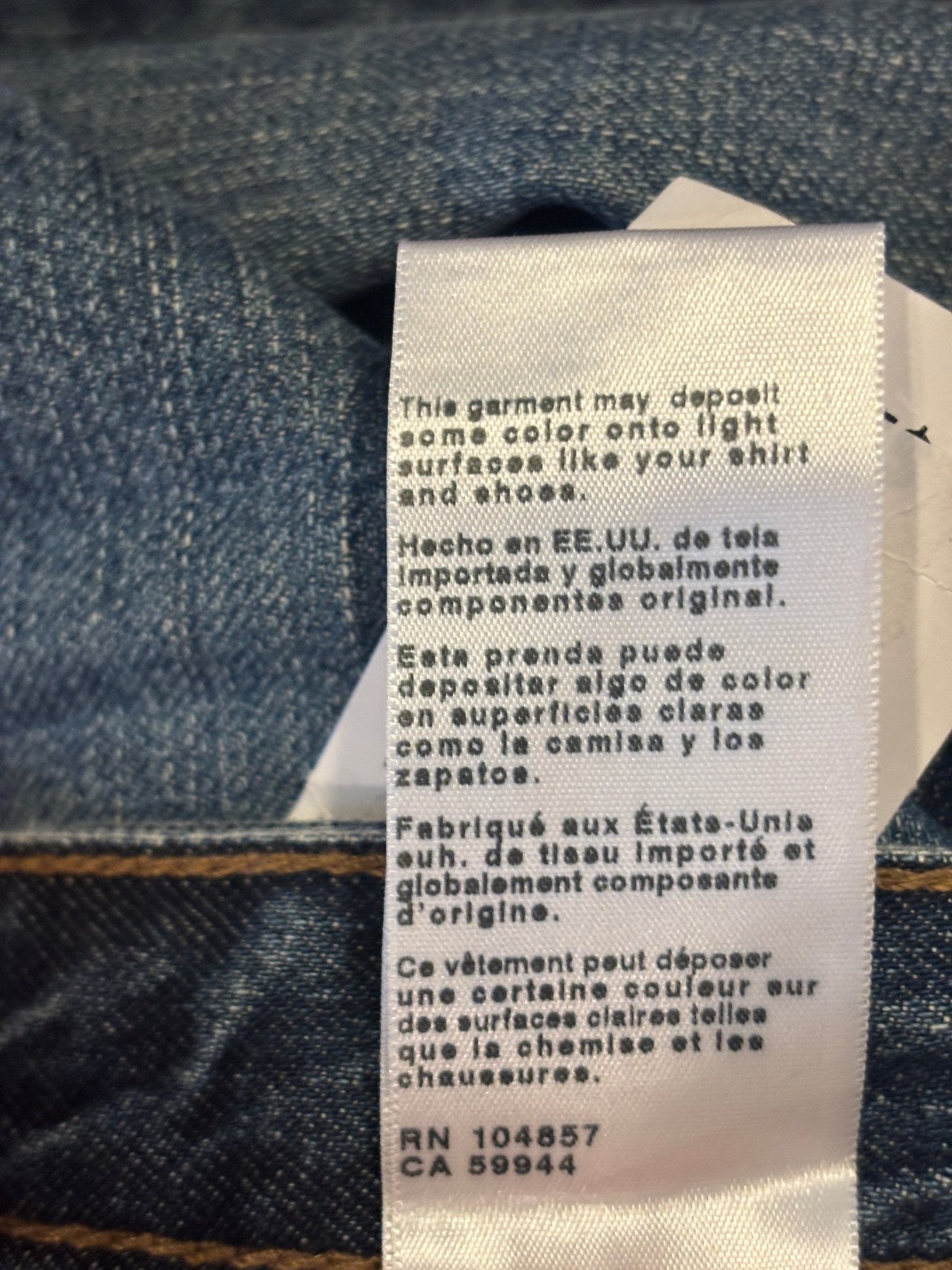 Interior factory tag and care label detail on AG Protégé jeans