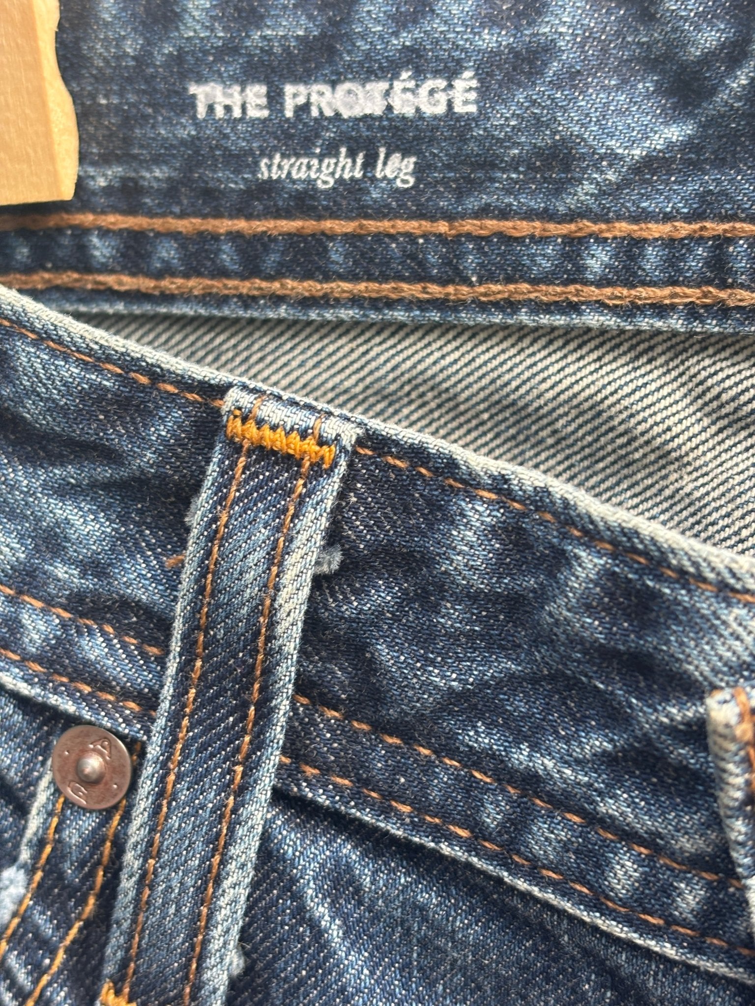 The Protégé straight leg label detail on AG denim