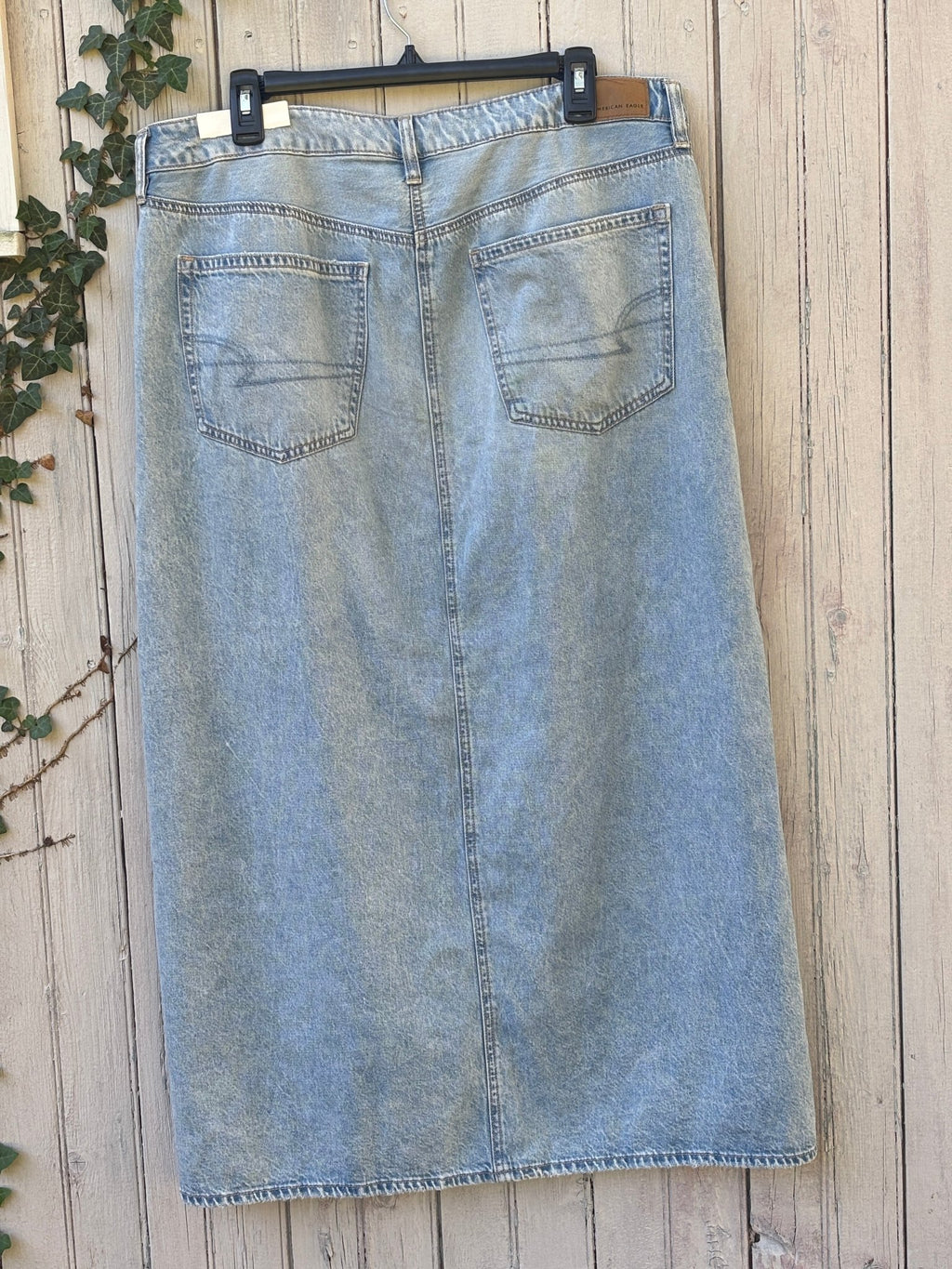 Full back view of American Eagle light wash denim maxi skirt showing back pockets