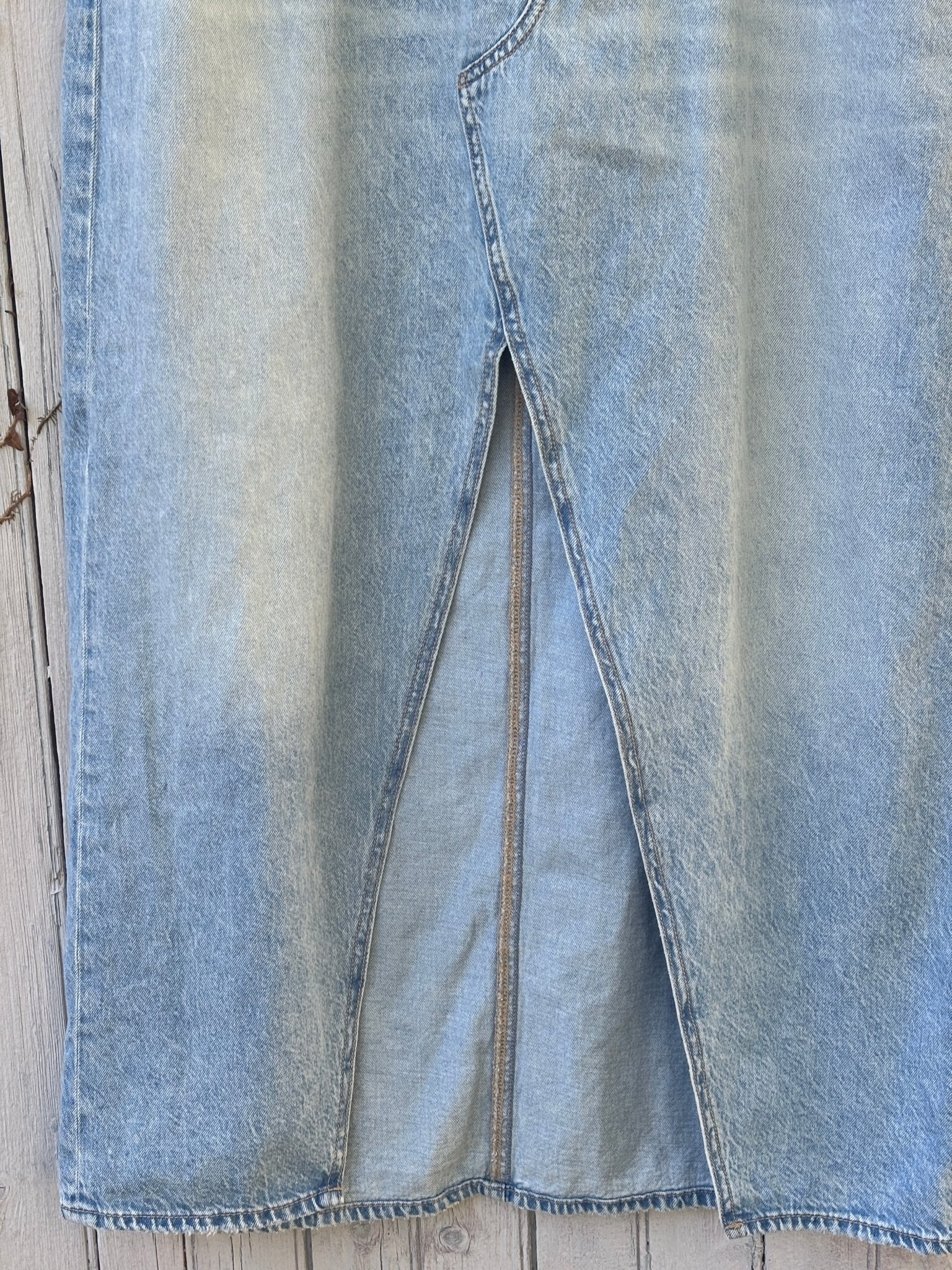 Close-up of front center slit on American Eagle light wash denim maxi skirt