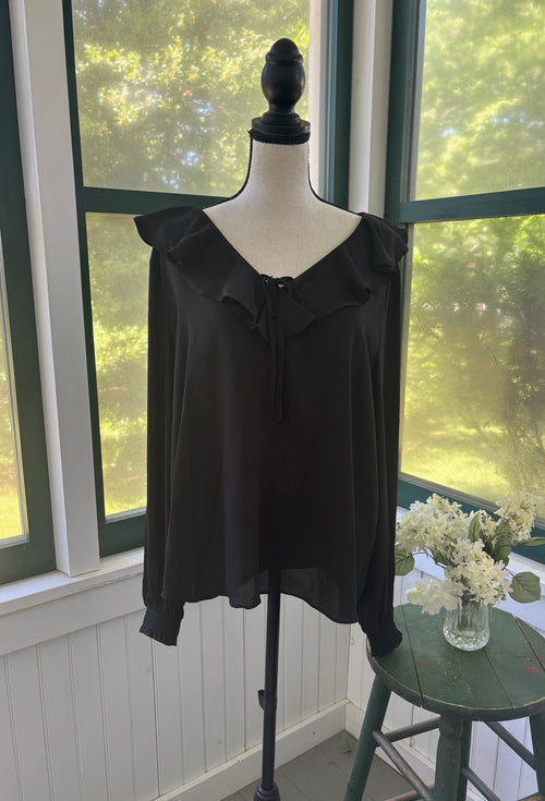 Ann Taylor black ruffle V-neck blouse on mannequin, wide ruffle collar with delicate self-tie and long flowing sleeves