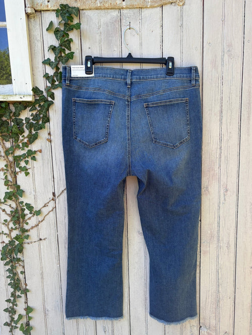 Back view of Ann Taylor Kick Crop high rise jeans showing sculpting pockets and raw frayed hem detail, size 16