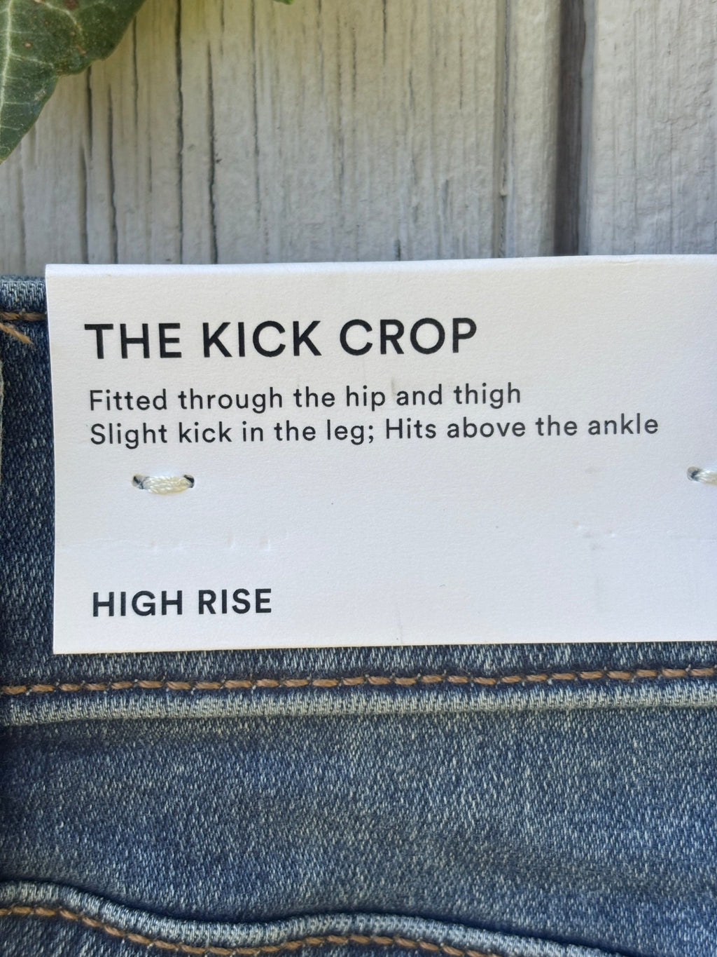 Ann Taylor hang tag showing The Kick Crop high rise style description on medium wash jeans