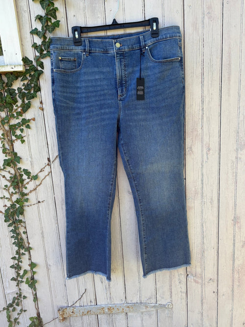 Ann Taylor Kick Crop high rise jeans in medium wash hanging on fence, front view showing slight flare and raw frayed hem, size 16 NWT