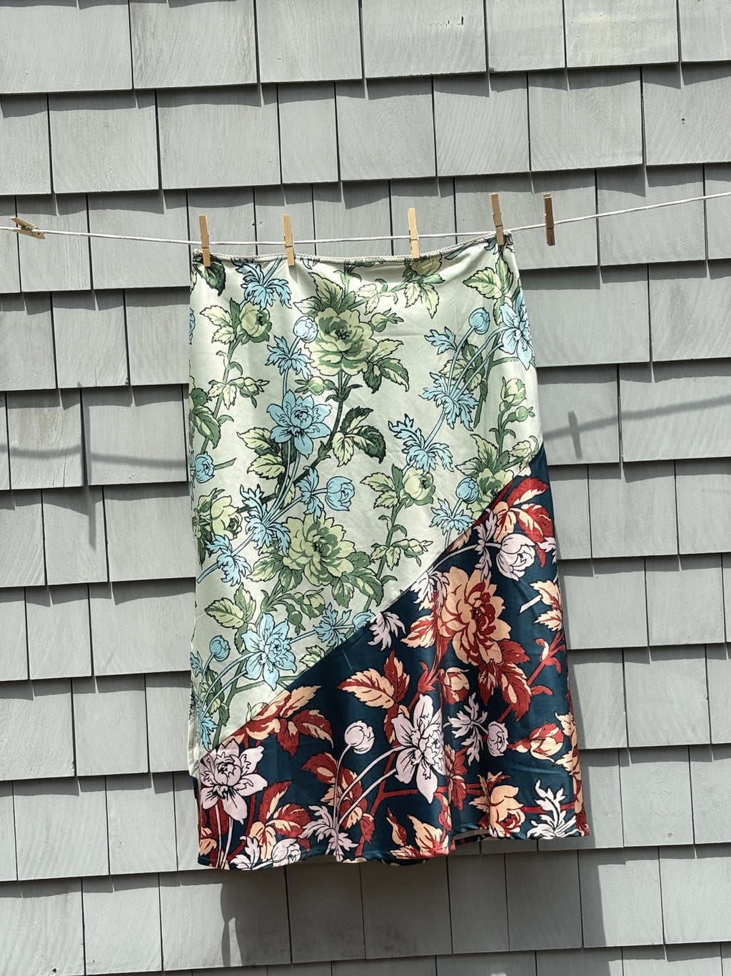 Back view of Anthropologie LyreBird floral midi skirt showing full length and colorblock diagonal seam