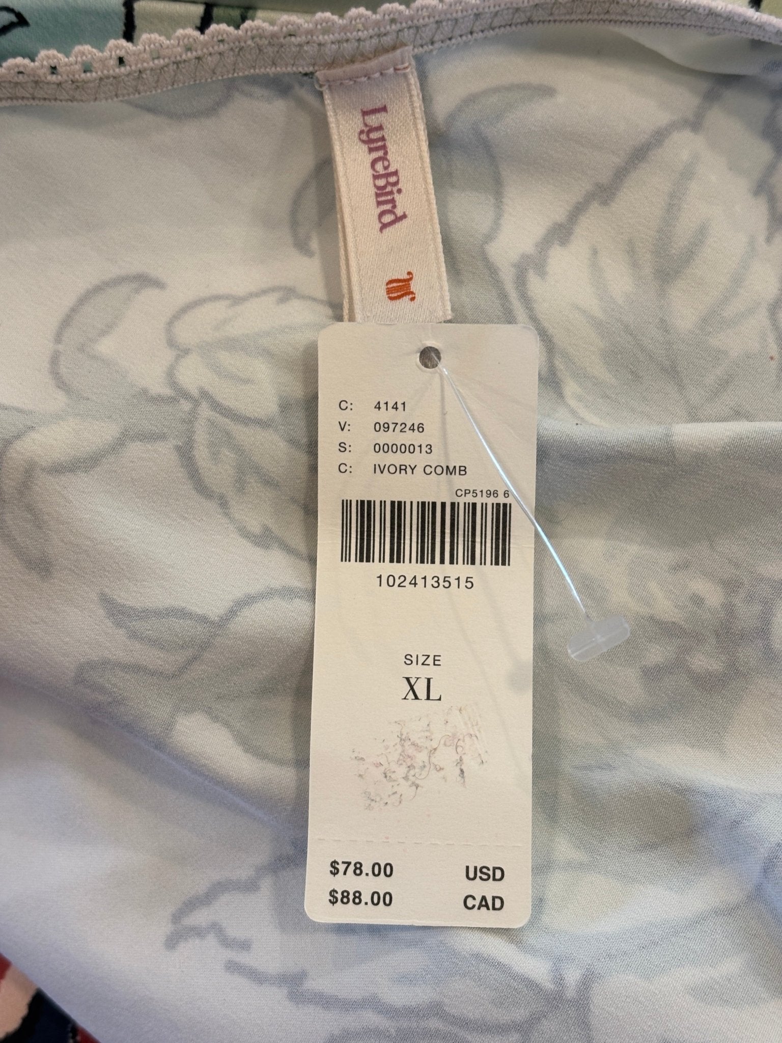 Hang tag showing LyreBird brand Anthropologie Ivory Comb colorway size XL retail $78