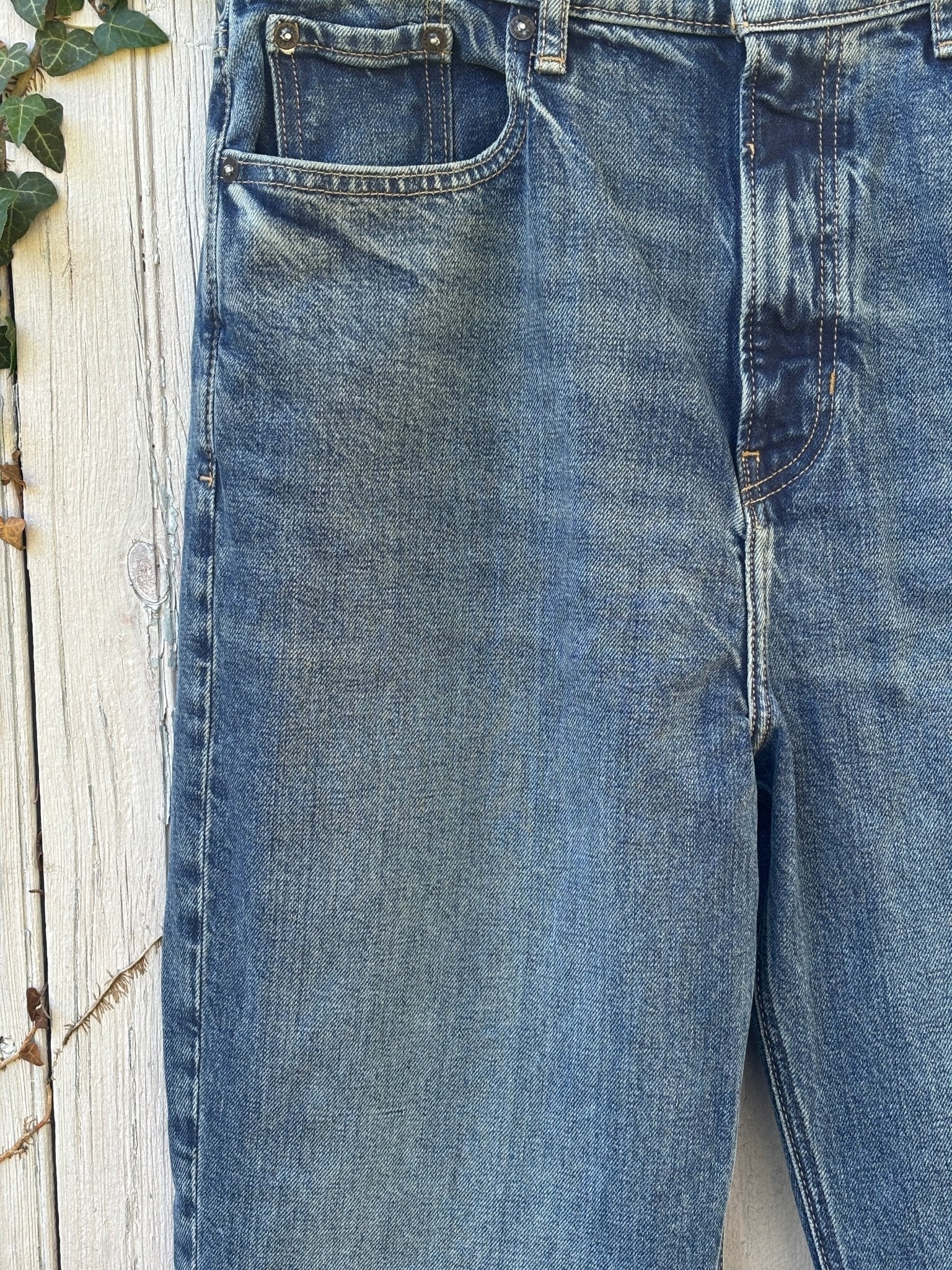 Close-up of waistband, front pockets and intentional thigh fading on Banana Republic bootcut jeans