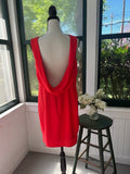 Back view of BCBG Max Azria Ellie mini dress in BT. Poppy coral red on dress form, showing dramatic deep cowl back drape