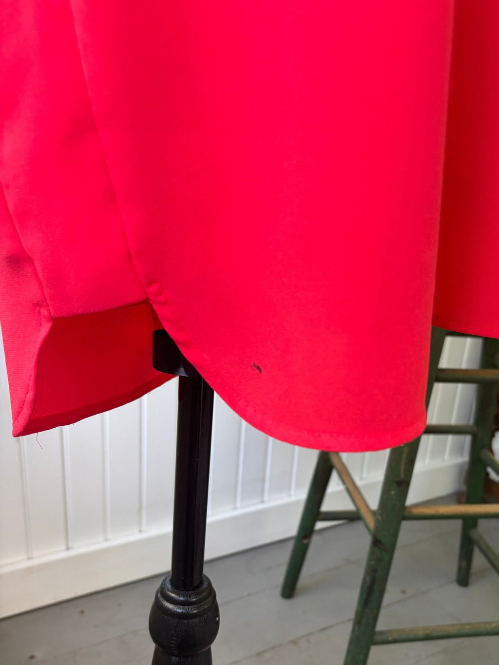Close-up of lower hem area showing small ink mark flaw near front hem edge