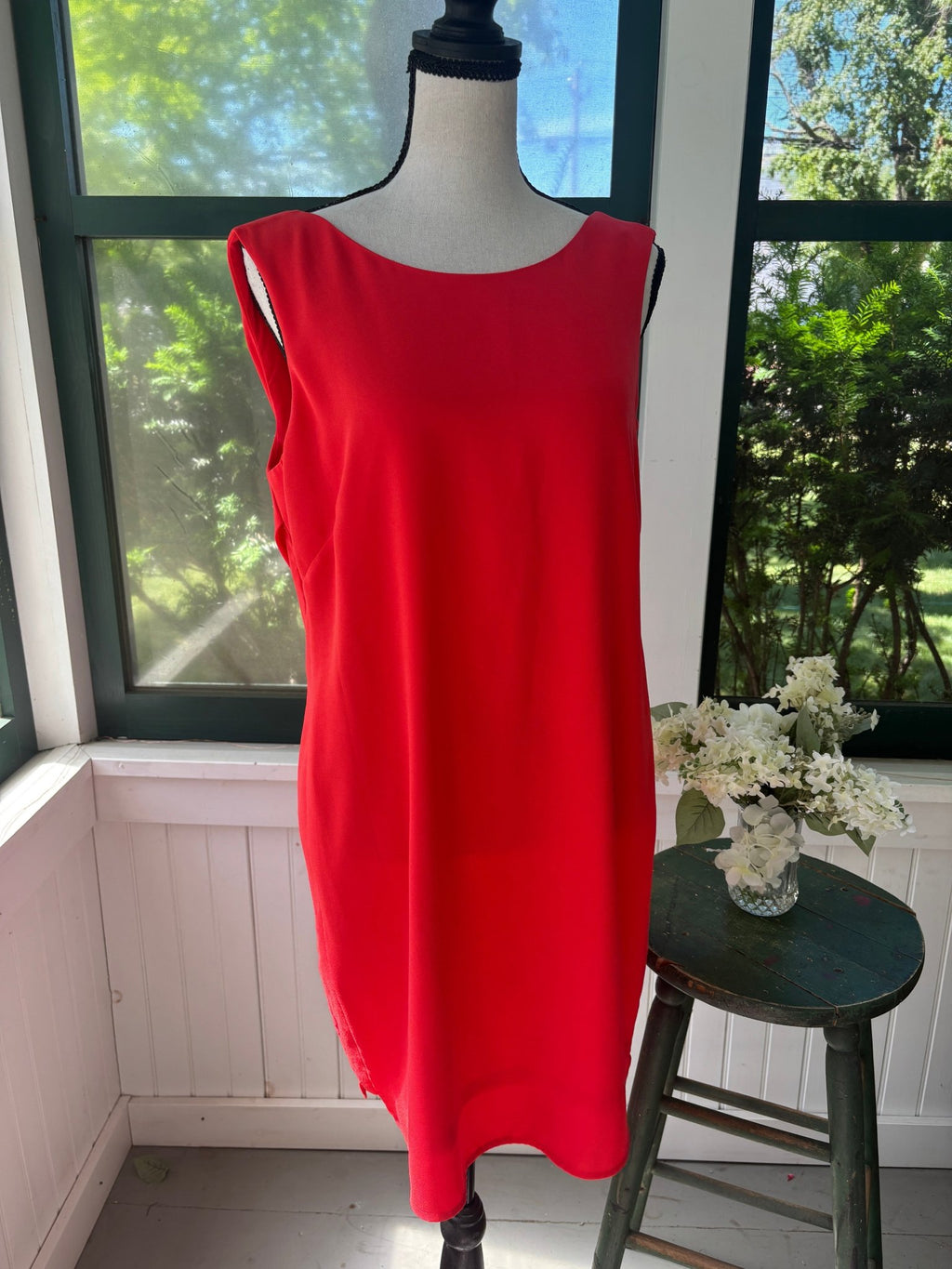 Front view of BCBG Max Azria Ellie mini dress in BT. Poppy coral red on dress form, showing dramatic deep cowl back drape