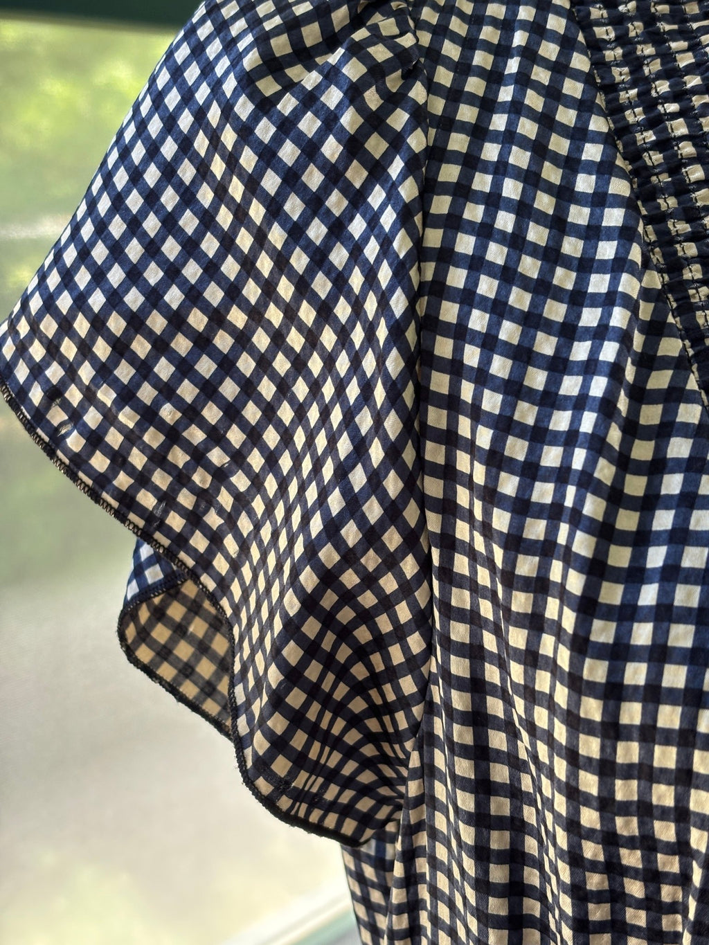 Detail of flutter sleeve on BCBG Max Azria black and cream silk gingham dress