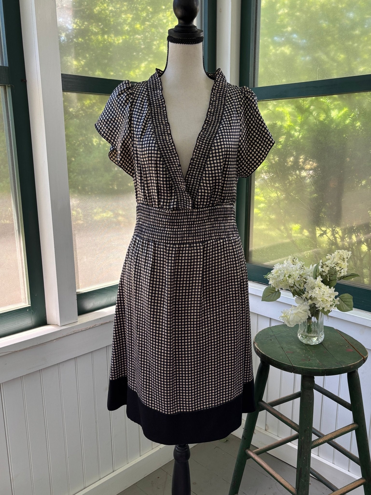 Like-new BCBG Max Azria black and cream silk gingham dress on dress form, full front view