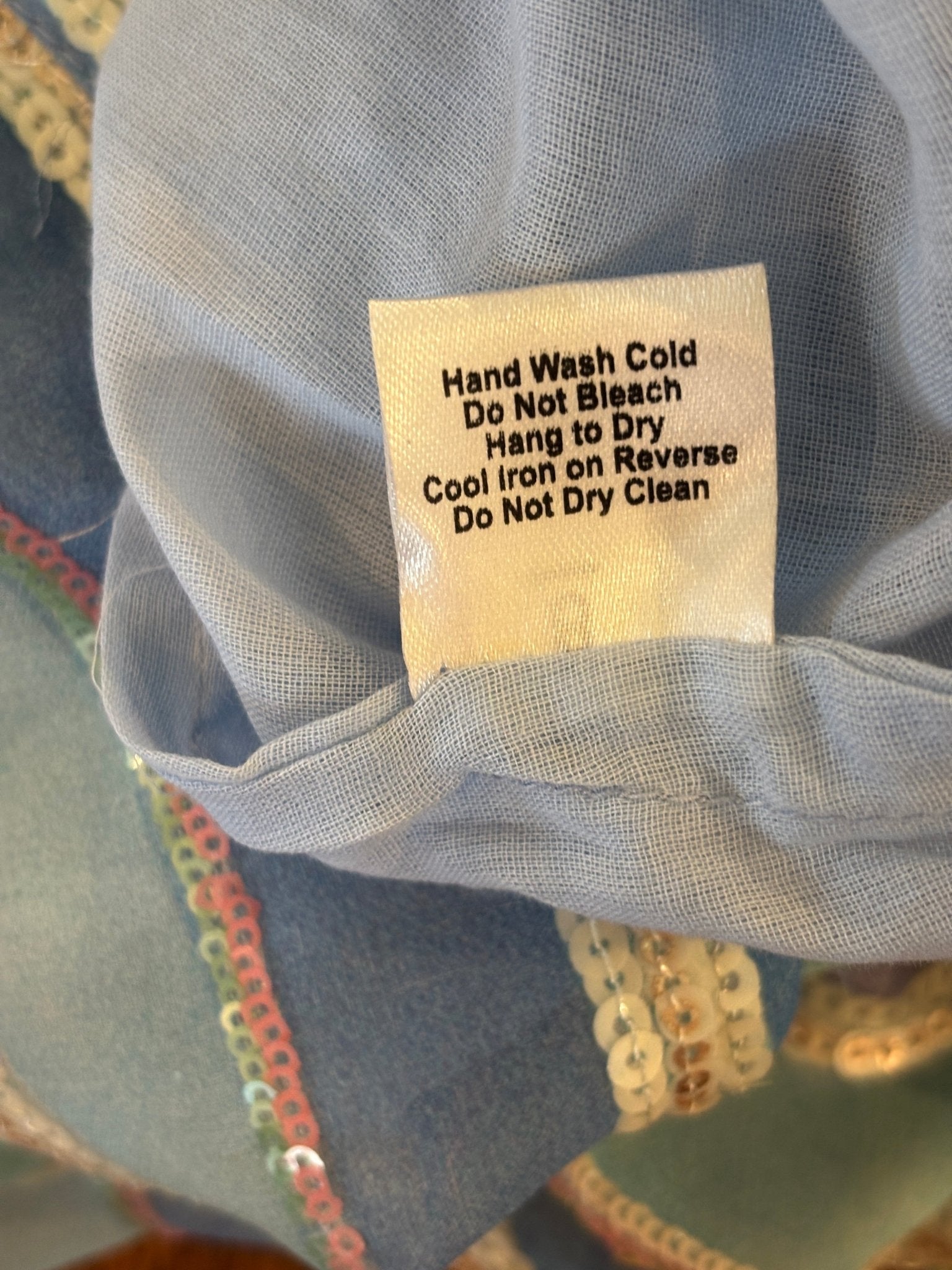 Care label showing hand wash cold, hang to dry, do not dry clean