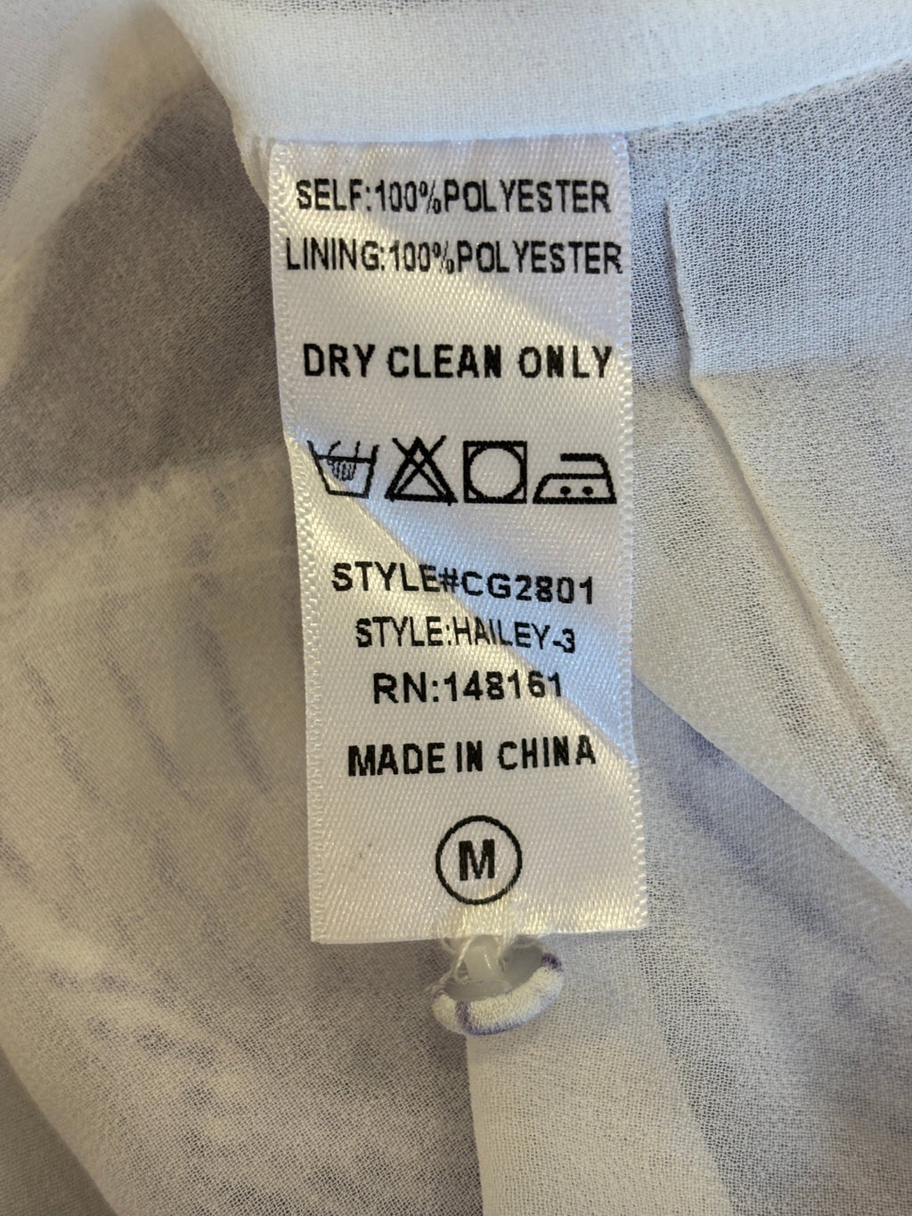 Care label showing 100% polyester dry clean only for BuddyLove Hailey Haze mini dress, style CG2801