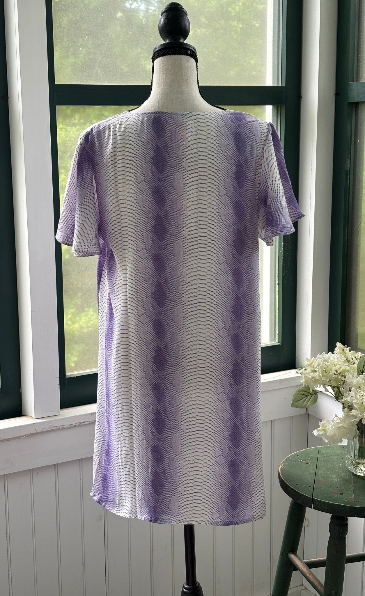 Back view of BuddyLove Hailey Haze lavender snake print mini dress showing A-line silhouette and short sleeves