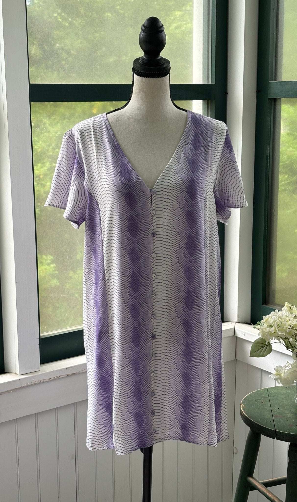 BuddyLove Hailey Haze lavender snake print mini dress on mannequin, V-neckline with button-down front and short sleeves, size Medium NWT