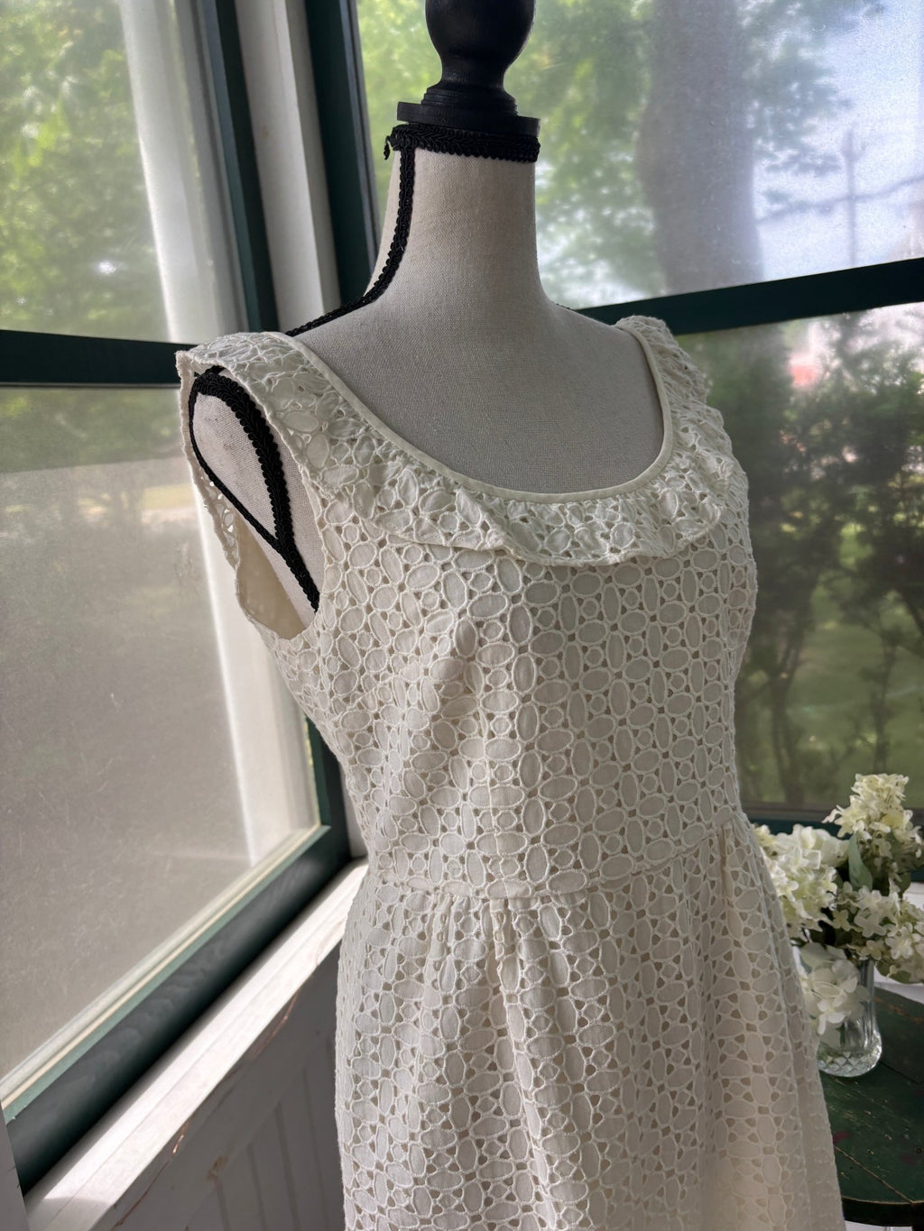 Close-up of ruffle shoulder and geometric crochet detail on Calypso St. Barth white dress