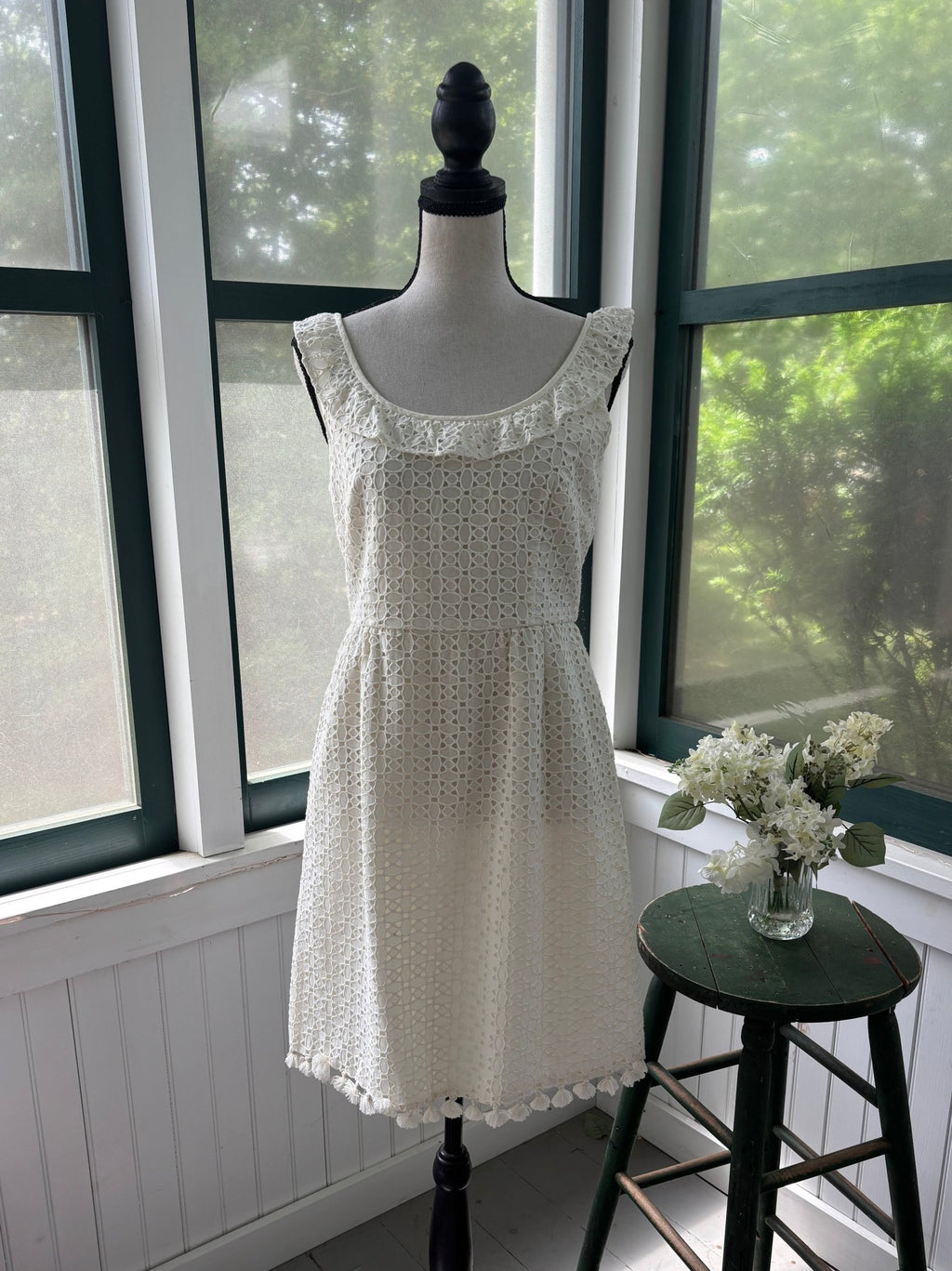 Calypso St. Barth white cotton crochet lace dress with tassel hem, front view on mannequin