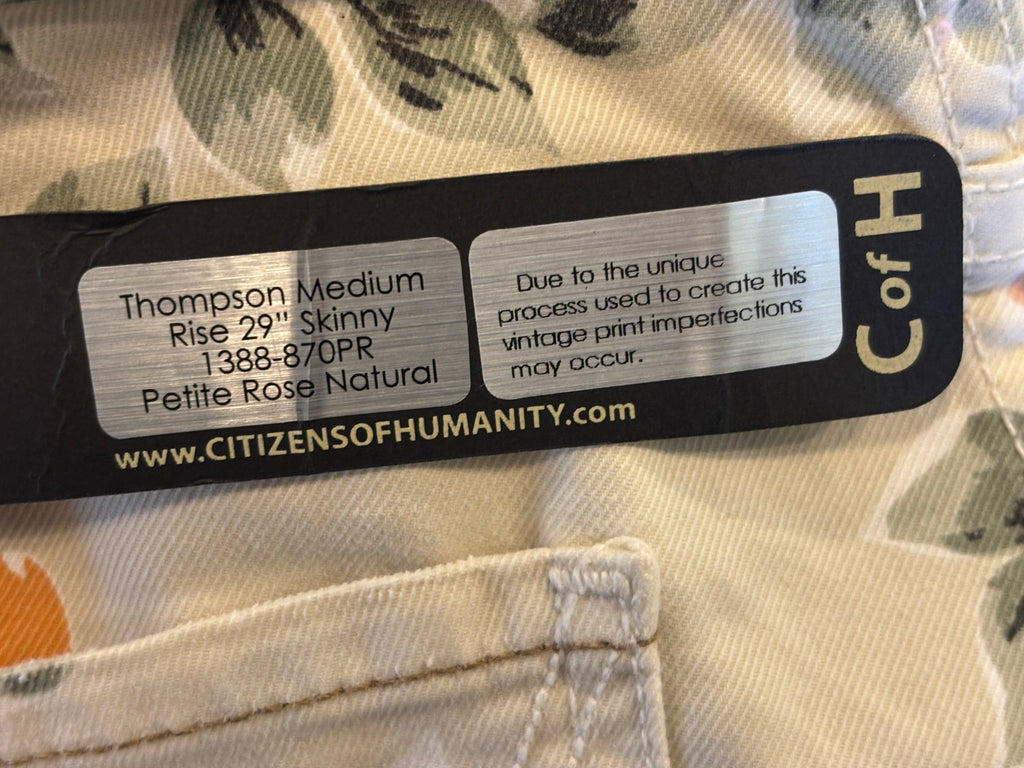 Interior hang tag sticker showing style name Thompson, colorway Petite Rose Natural, and vintage print disclosure note