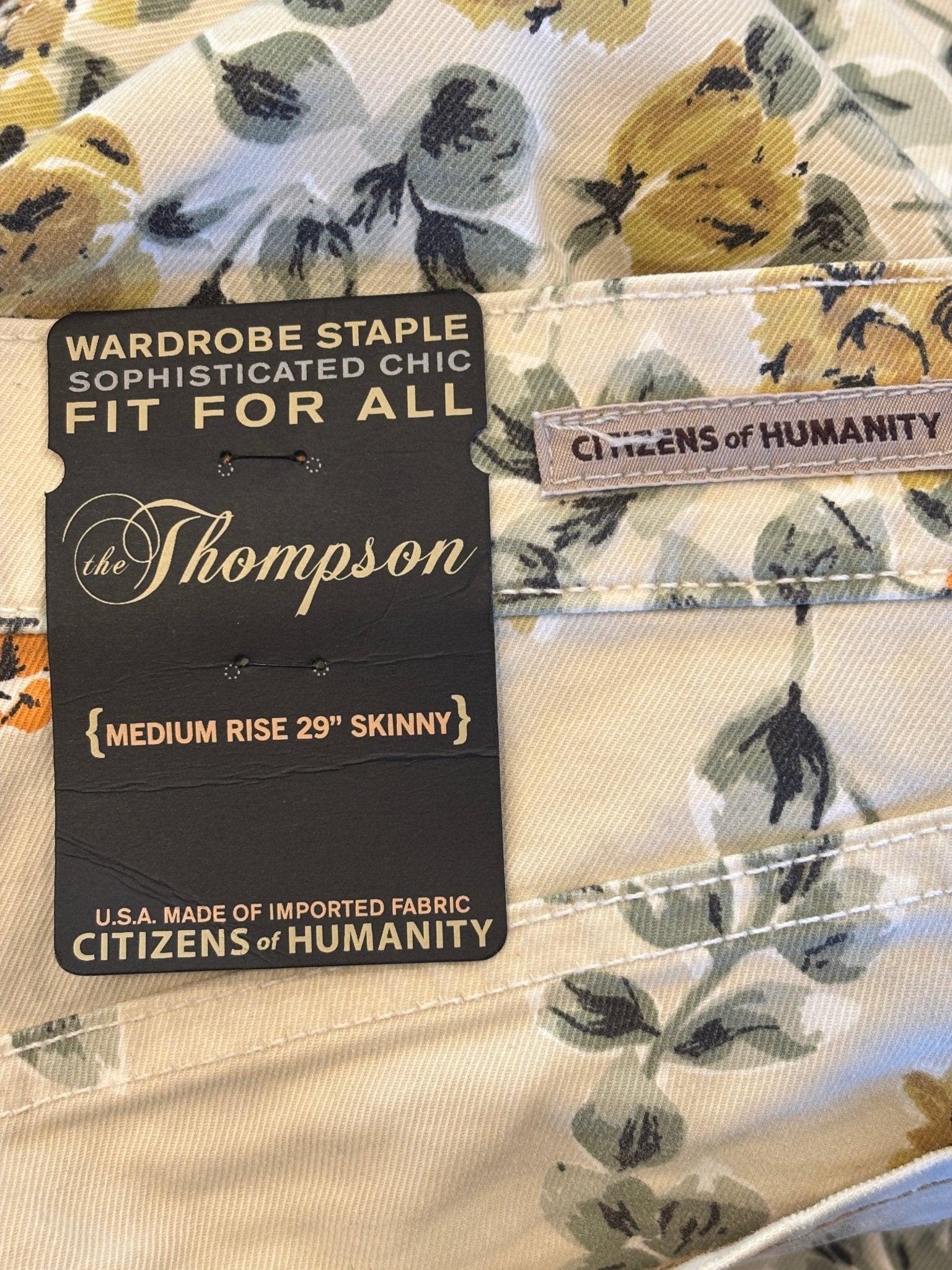 Close-up of hang tag reading "The Thompson — Medium Rise 29" Skinny — Citizens of Humanity"