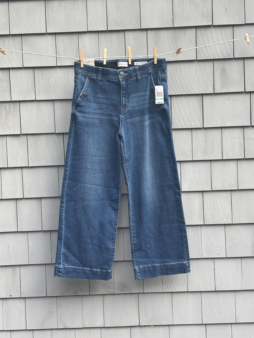 Curve Appeal Heritage Luxe wide leg crop jeans hanging on clothesline, front view with tags
