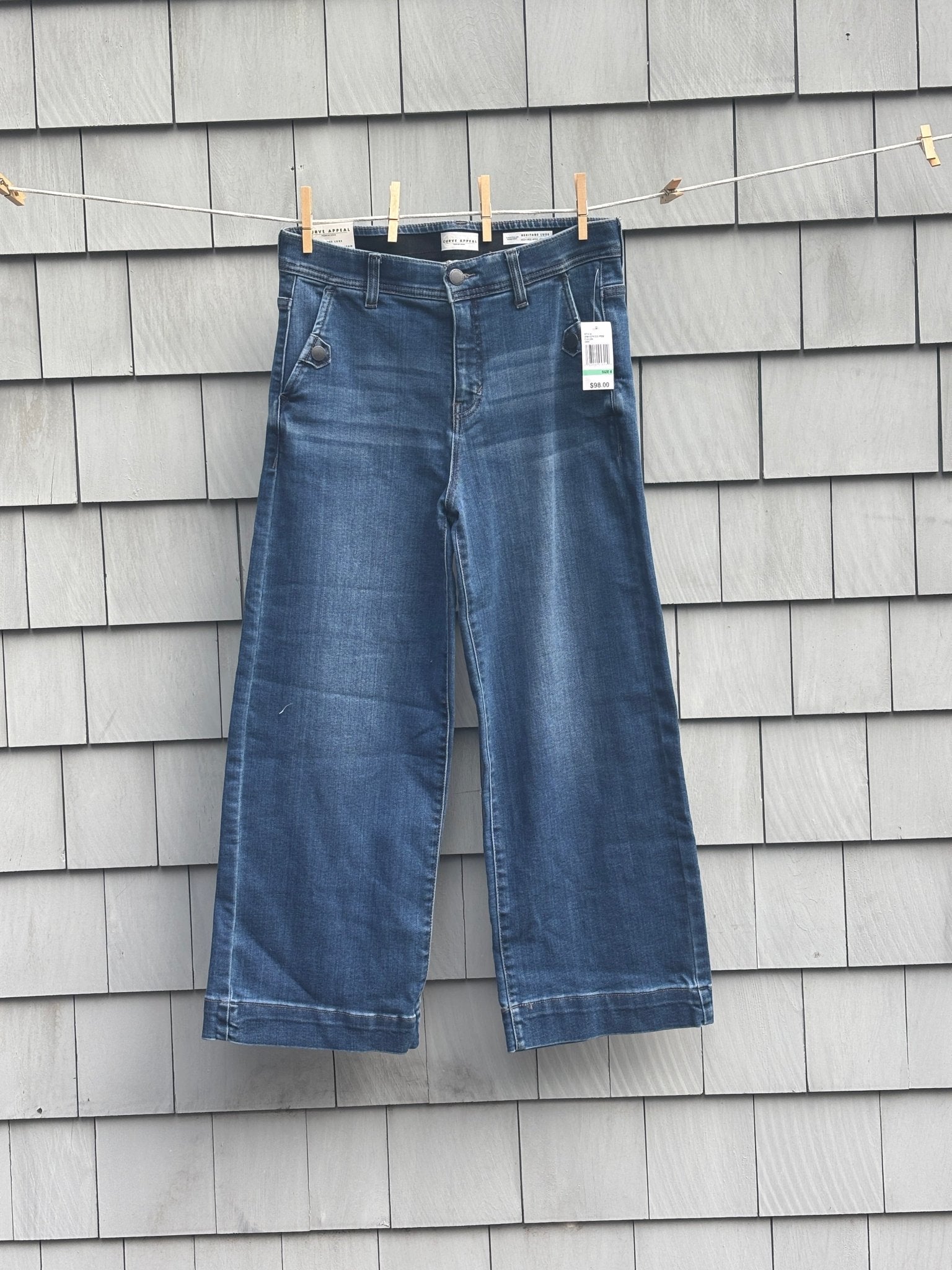 Curve Appeal Heritage Luxe wide leg crop jeans hanging on clothesline, front view with tags