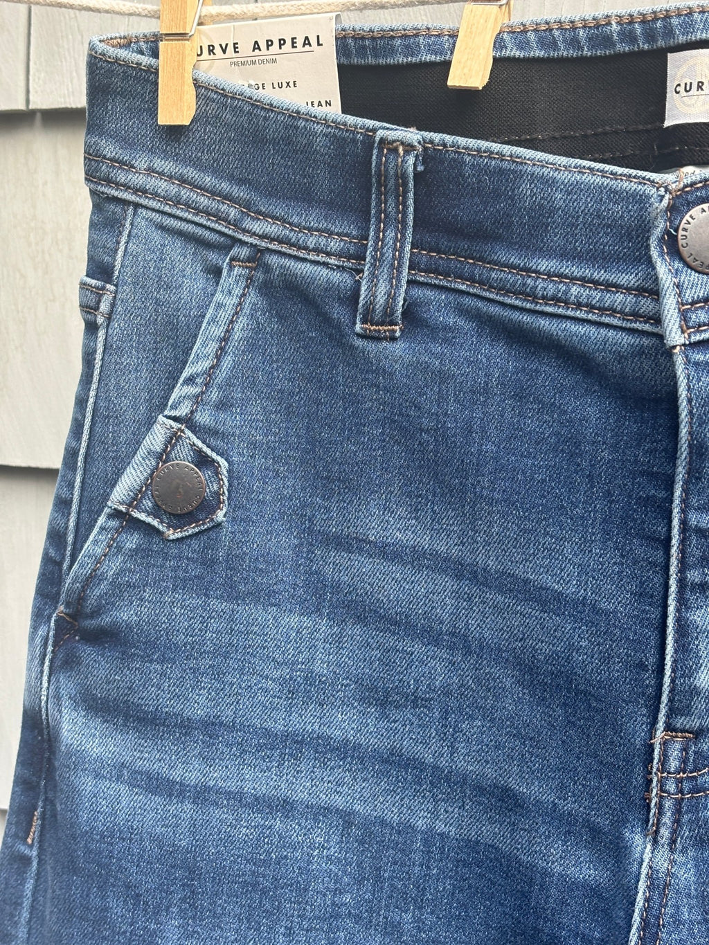 Close-up of front pocket and button detail on Curve Appeal wide leg crop jeans