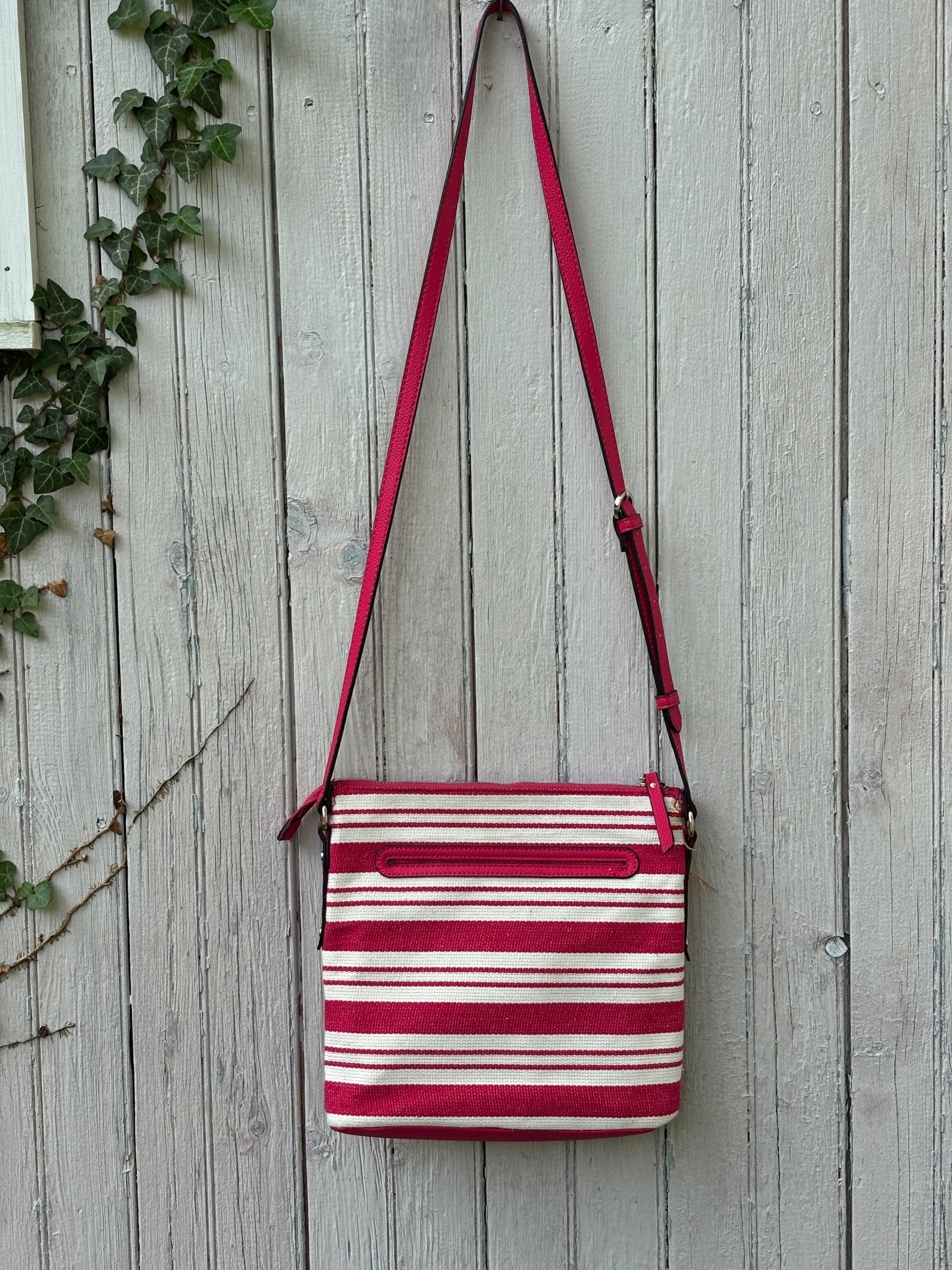 Back view of Dana Buchman red and cream stripe canvas crossbody bag showing clean structured silhouette and adjustable strap