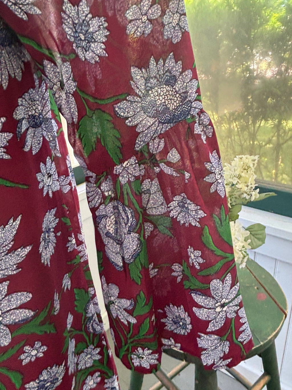 Detail of open cold-shoulder cutout and bell sleeve on Entro burgundy floral dress