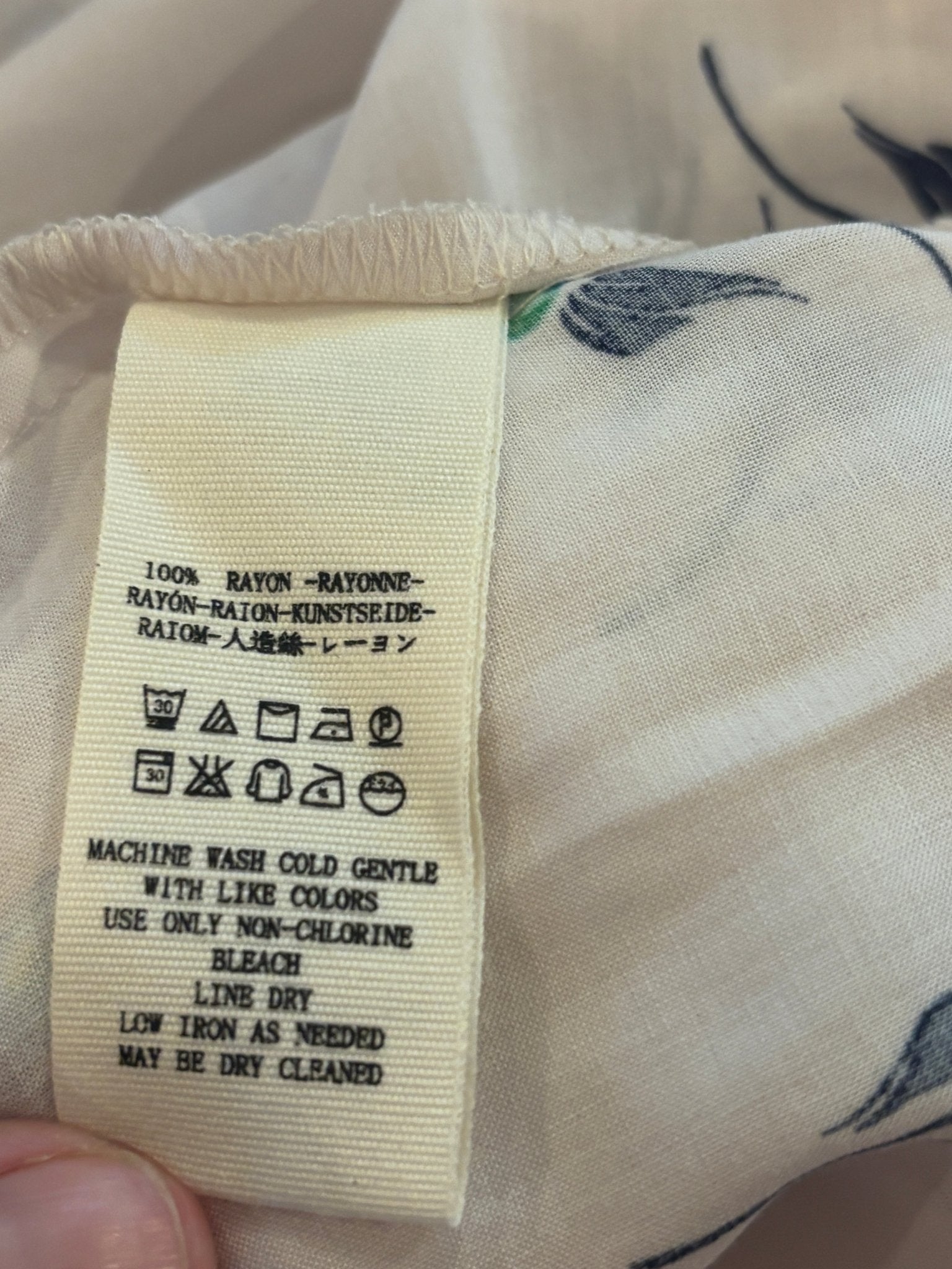 Care label showing 100% rayon fabric content for Free People floral dress