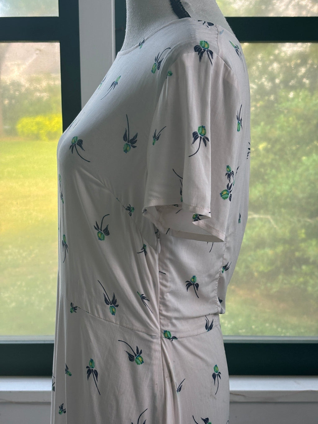 Free People floral mini dress, side view showing fitted waist seam and sleeve