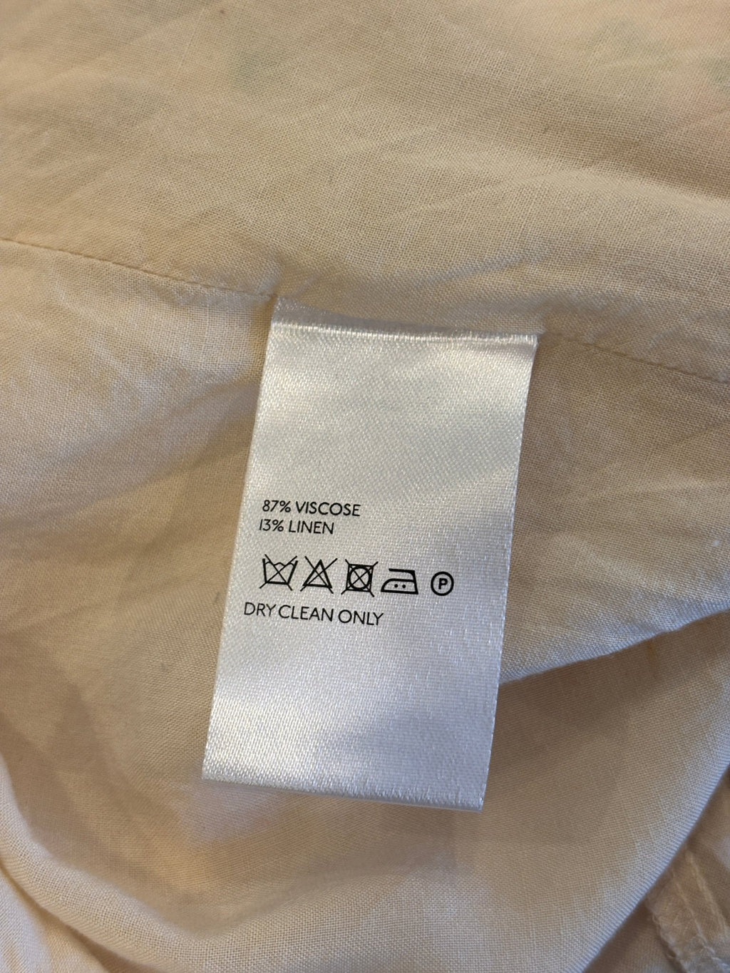 Second care label showing 87% viscose 13% linen, dry clean only symbol