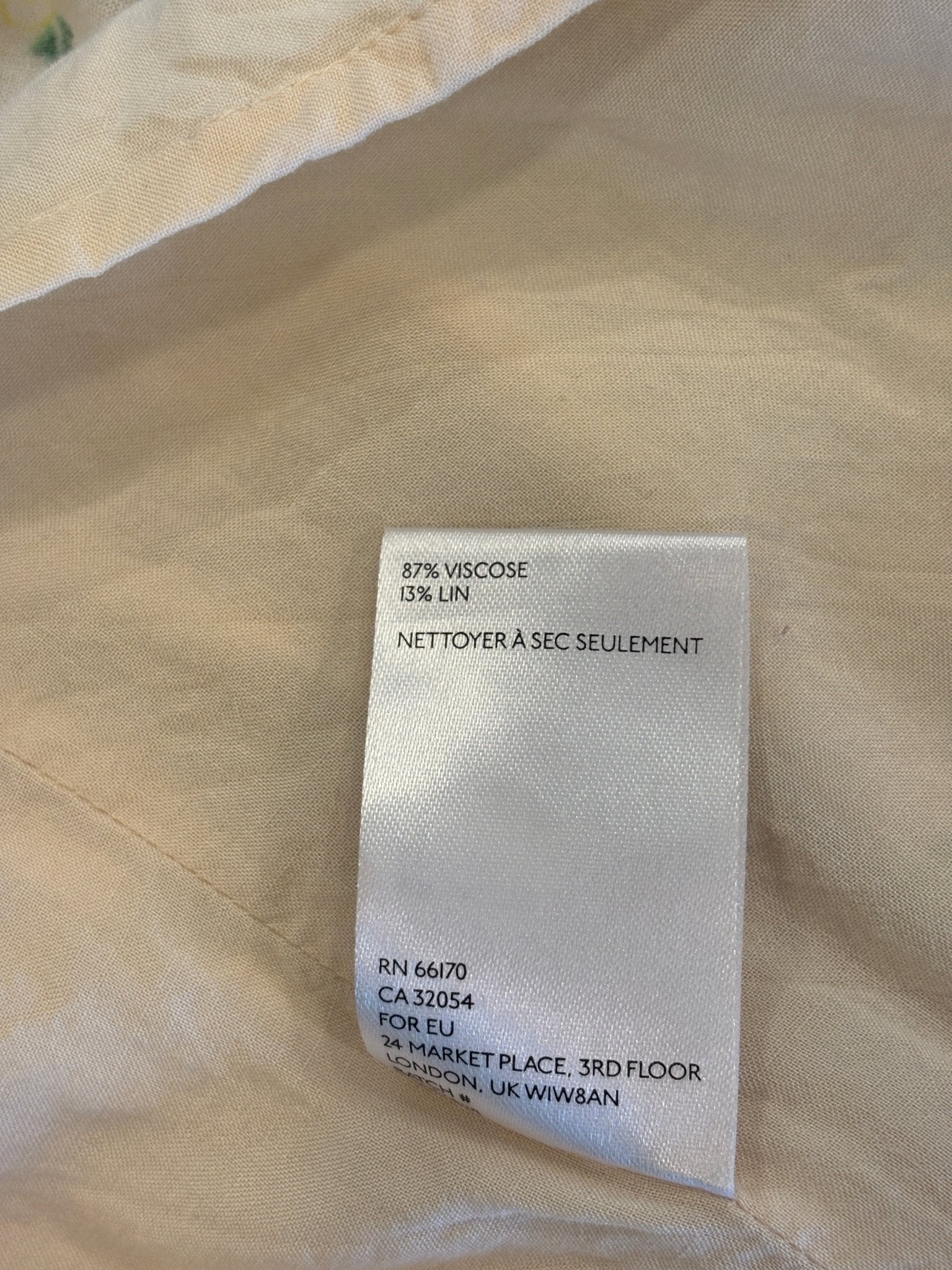 Interior care label showing 87% viscose 13% linen, dry clean only, EU address (RN 66170)