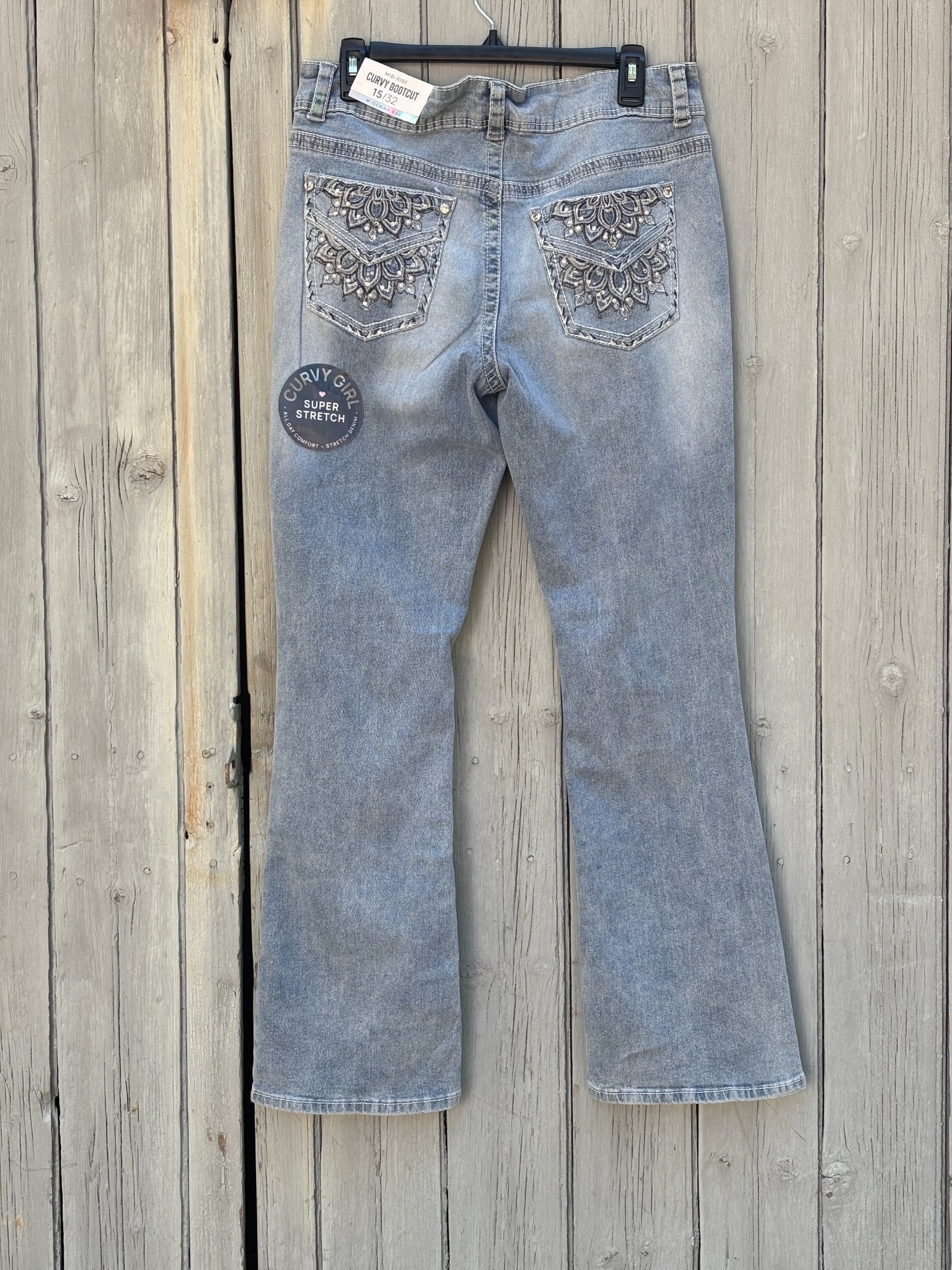 Back view showing two heavily embellished mandala-embroidered back pockets with rhinestones and pearl beads, Curvy Girl Super Stretch hangtag visible