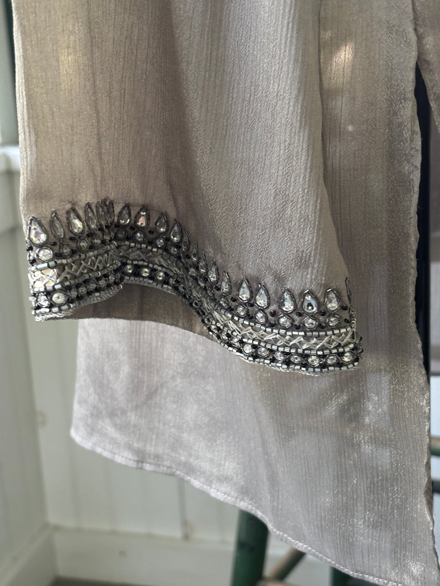Back view of Grids by Sulu Collection taupe beaded tunic dress showing relaxed silhouette and beaded neckline trim