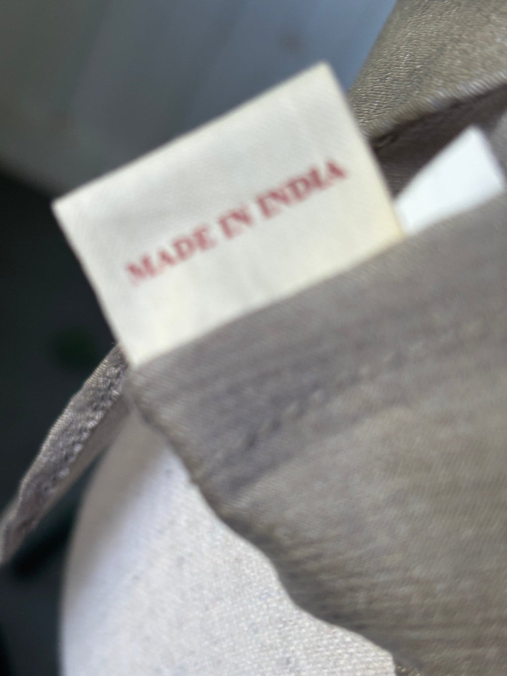 Made in India label inside Grids by Sulu Collection taupe beaded tunic dress