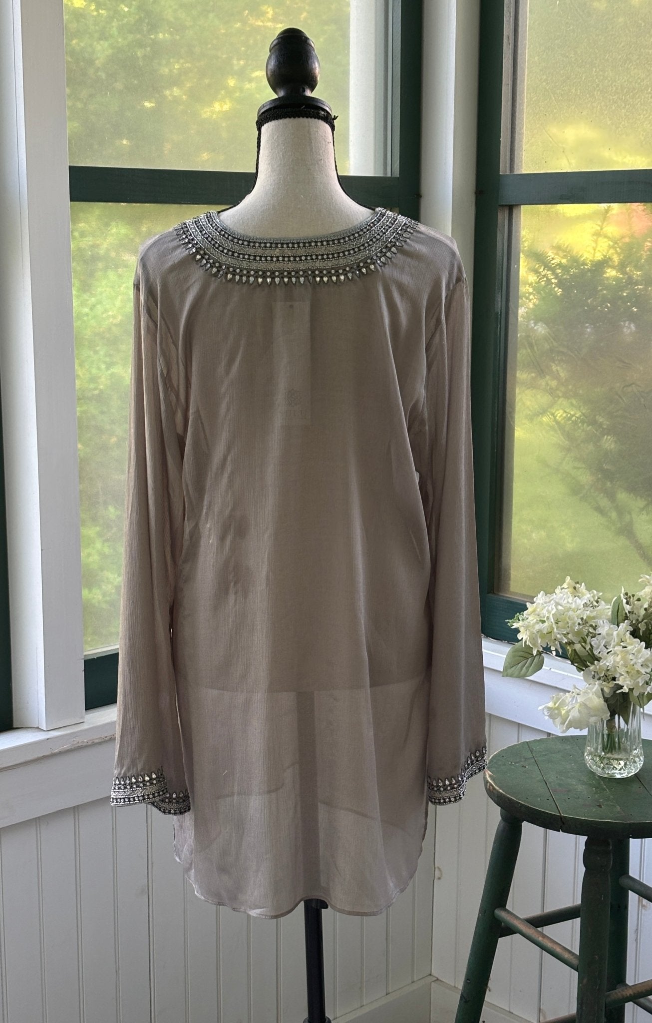 Close-up of crescent-shaped rhinestone and seed bead cuff detail on long sleeve of Grids by Sulu Collection taupe tunic dress