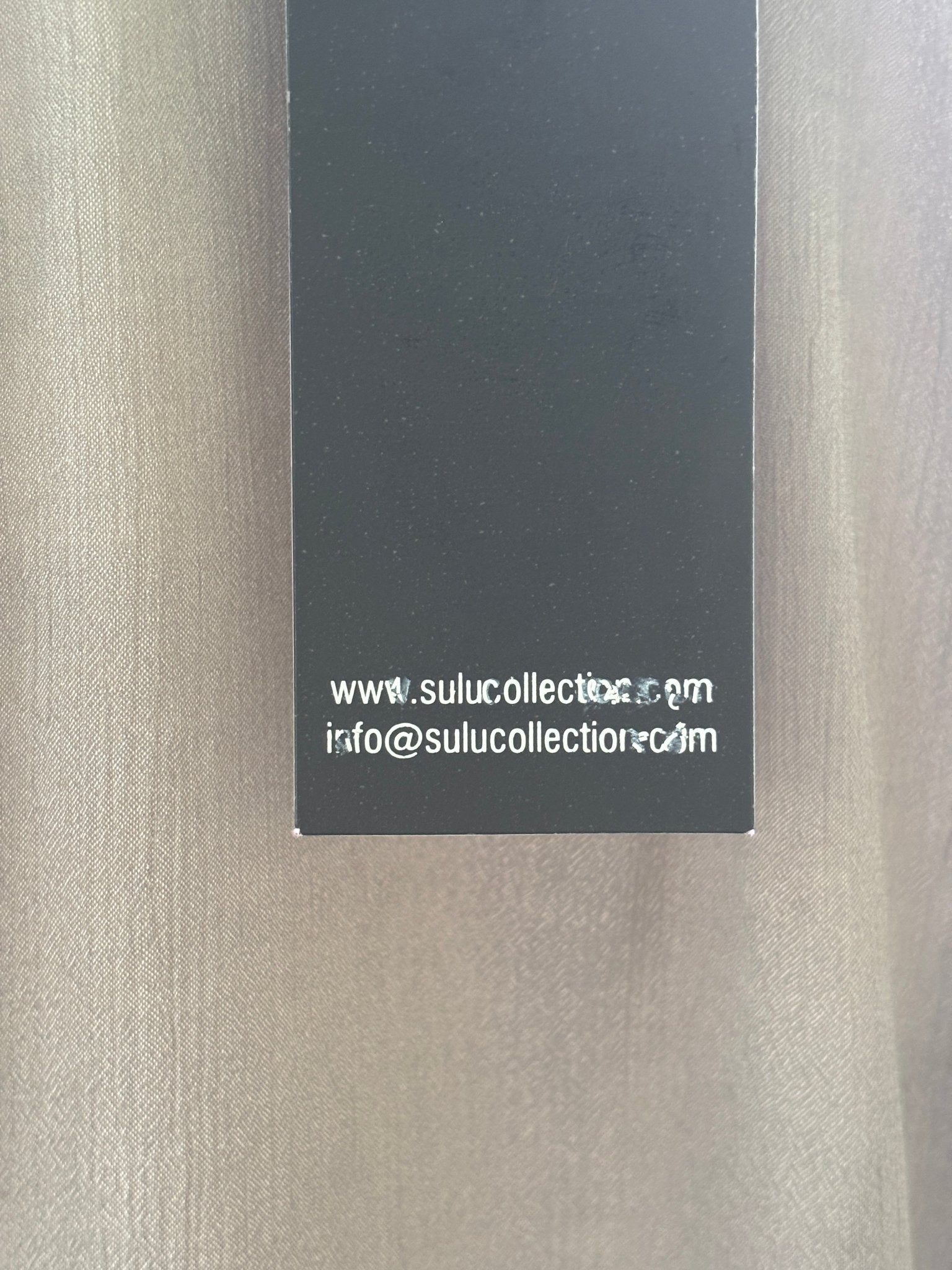 Hang tag showing sulucollection.com on Grids taupe beaded tunic dress